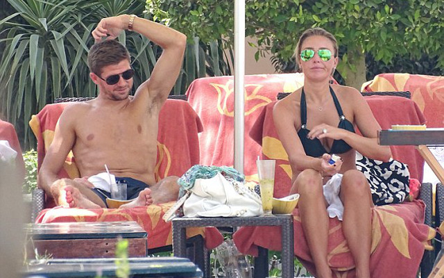 Steven Gerrard and Alex Curran by a swimming pool