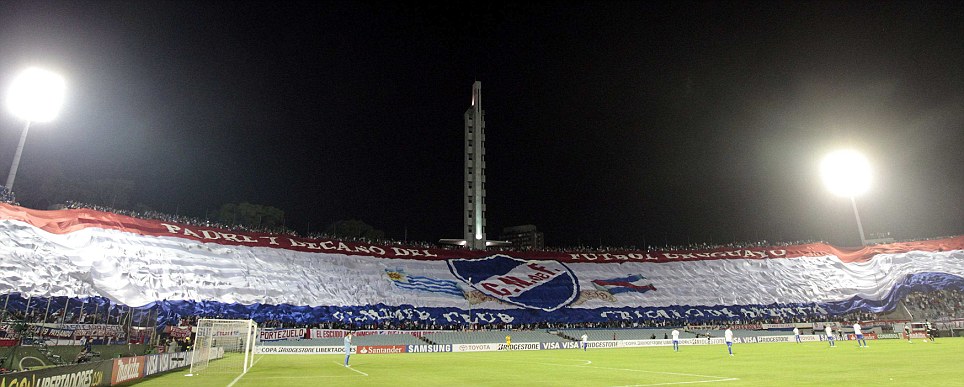 Fans of Nacional display a giant flag during Copa Libertadores match against Mexico's Toluca in Montevideo