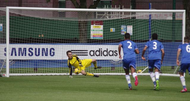 Young Chelsea goalkeeper Jared Thompson saving a penalty