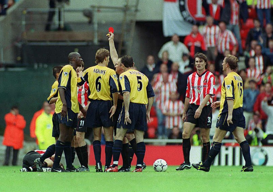 Blackburn players swarm around ref
