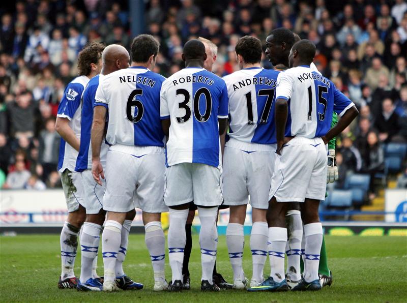 Blackburn players swarm around ref