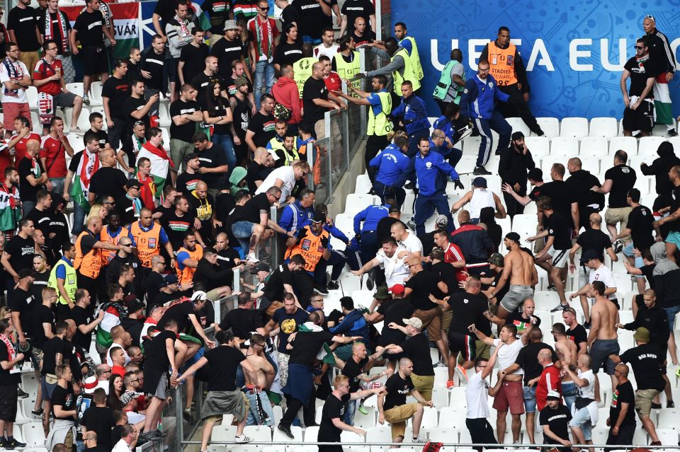 Match stewards (in blue) try to control fans from Hungary before the start of the Euro 2016 group F football match between Iceland and Hungary at the Stade Velodrome in Marseille on June 18, 2016. / AFP PHOTO / BERTRAND LANGLOISBERTRAND LANGLOIS/AFP/Getty Images