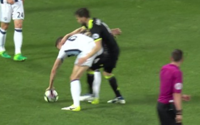 Jonny Evans handballs away from Cesc Fabregas