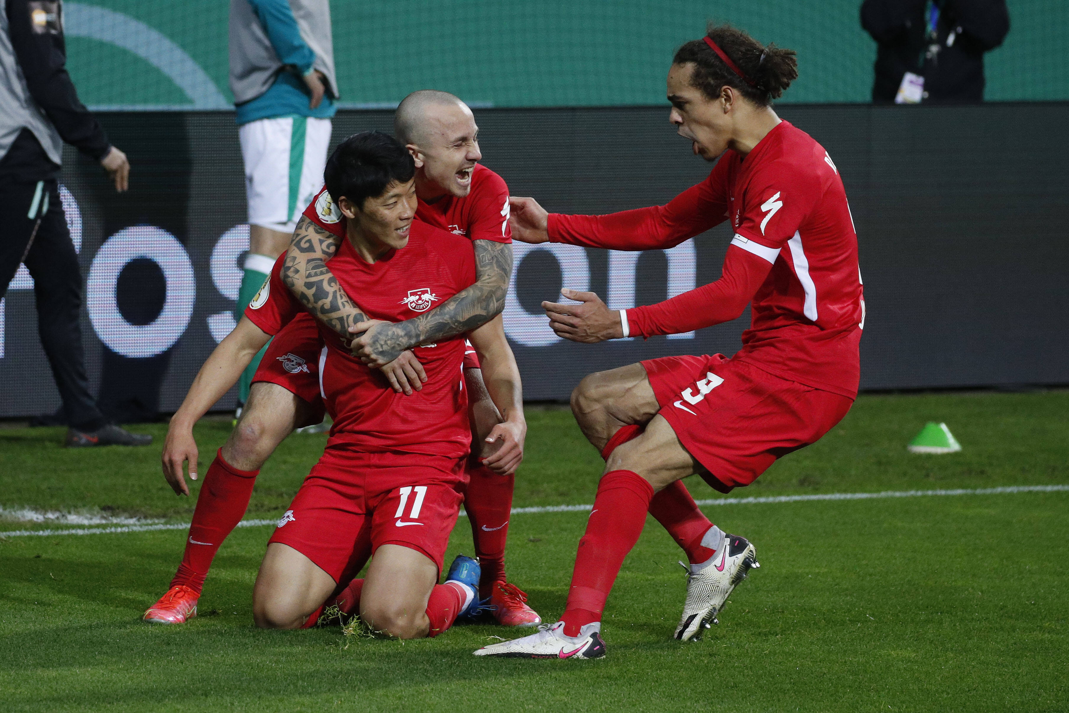 Hwang Hee-Chan celebrates with Angelino and Poulsen for RB Leipzig