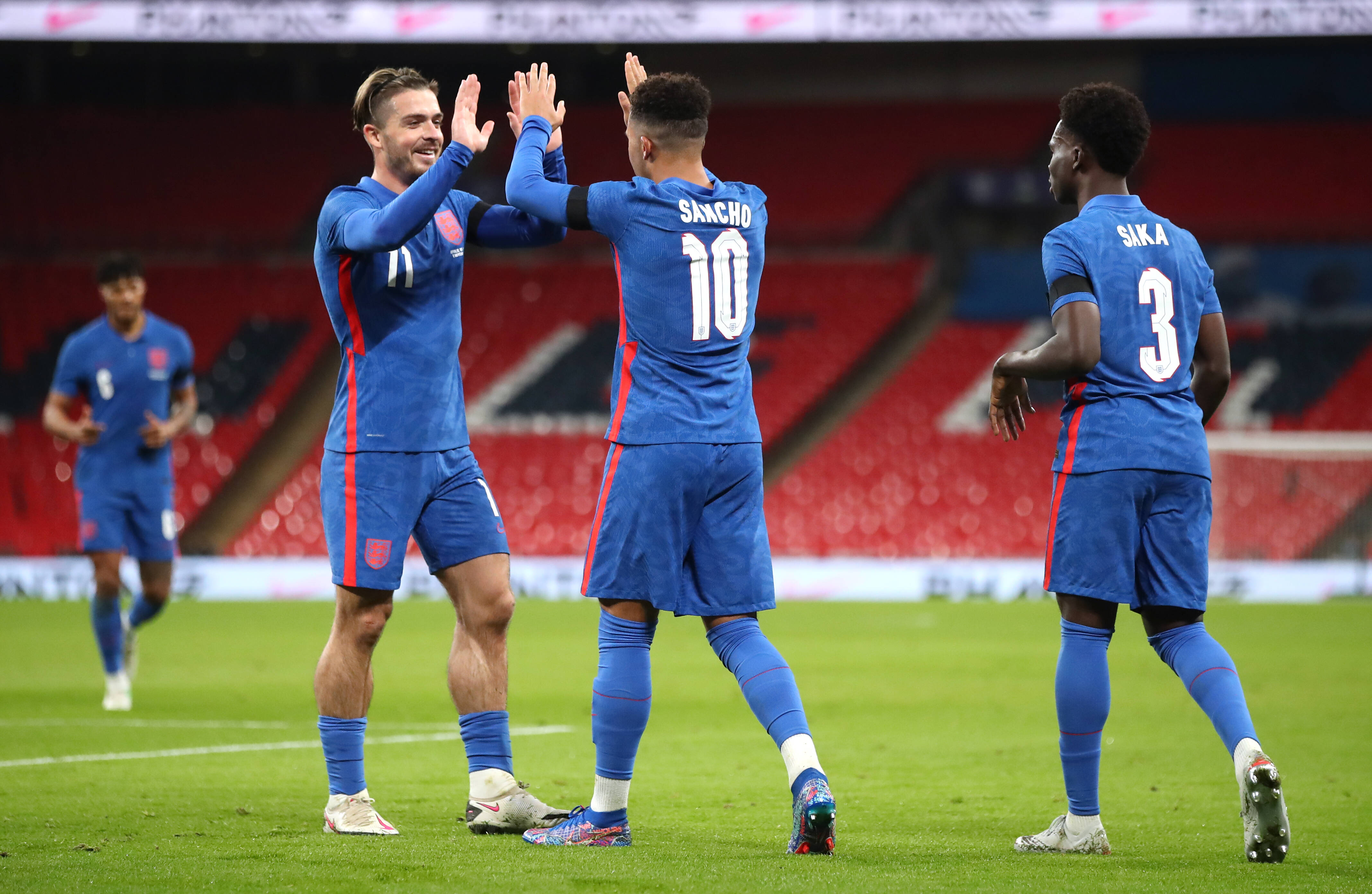 Jack Grealish and Jadon Sancho celebrate for England