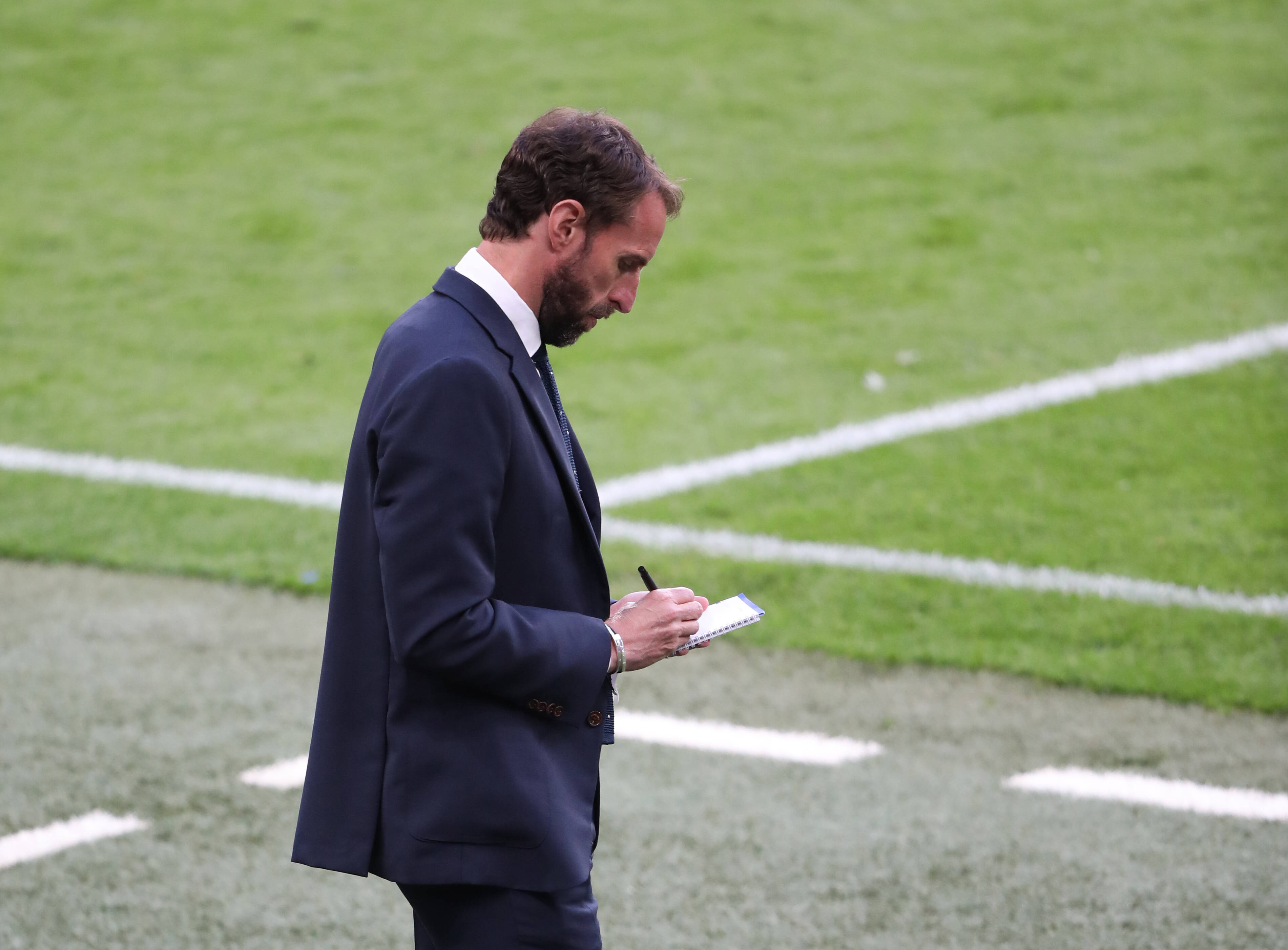 Gareth Southgate taking notes while England play