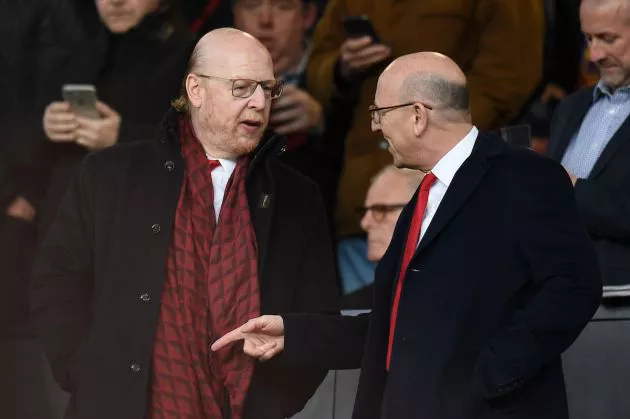 The Glazer brothers talk in the stands