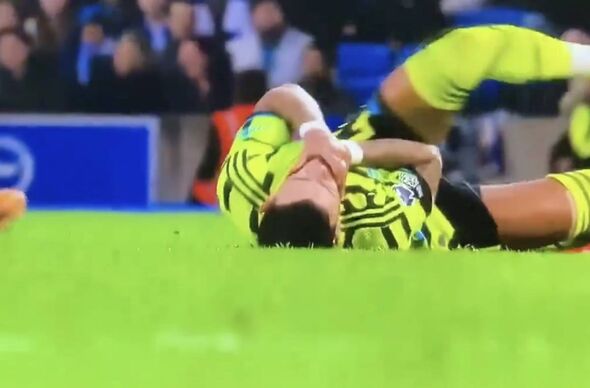 Arsenal's Ben White holding his neck after minor incident with Pervis Estupinan