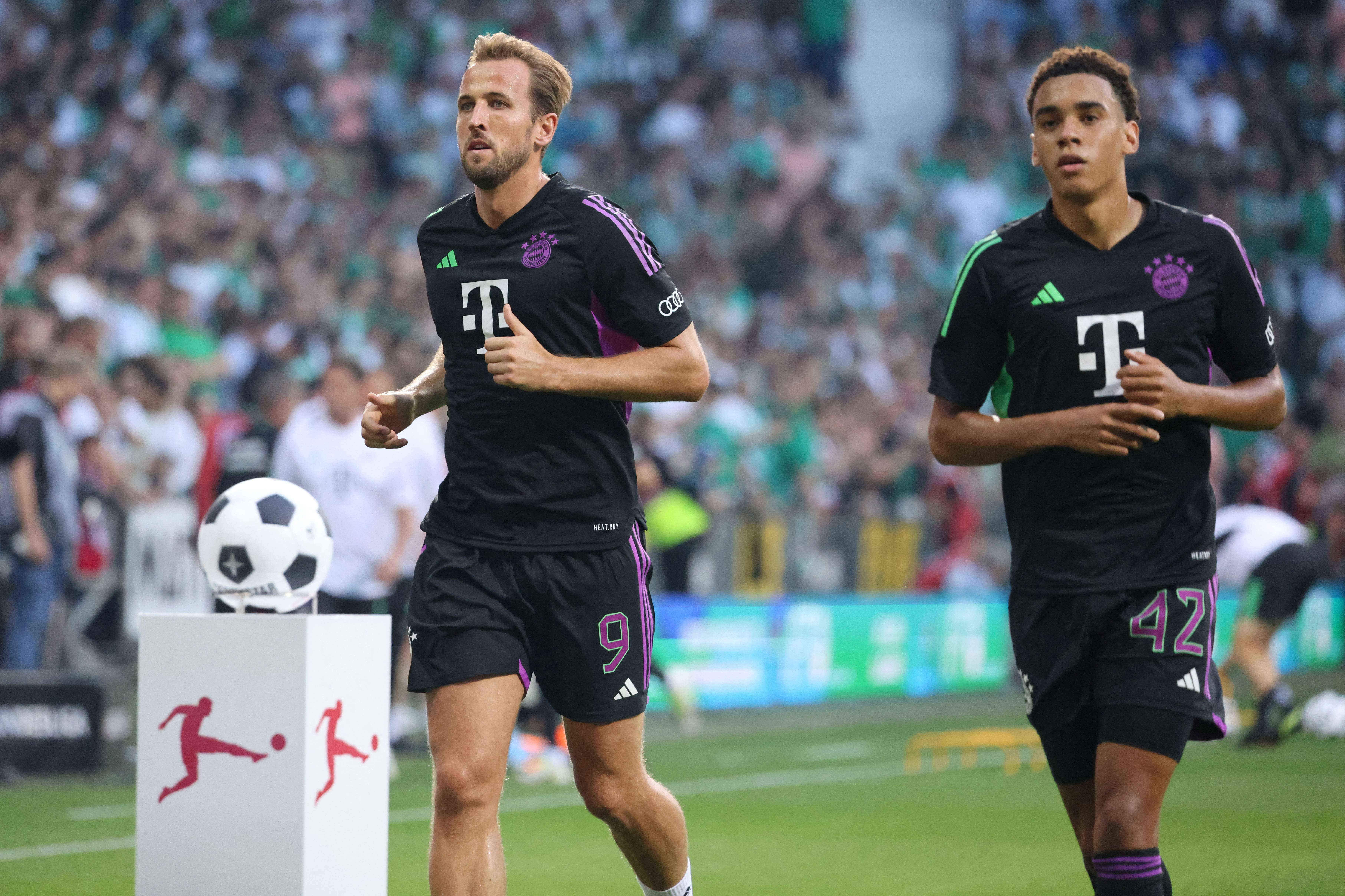 Harry Kane and Jamal Musiala warming up ahead of Bayern Munich's Bundesliga match against Werder Bremen on August 18, 2023.