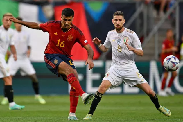 Spain's midfielder Rodrigo Hernandez kicks the ball past Italy's midfielder Jorginho during the UEFA Nations League semi final football match between Spain and Italy at the De Grolsch Veste Stadium in Enschede on June 15, 2023.