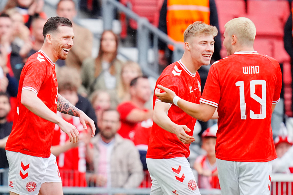 Denmark's forward #09 Rasmus Hojlund (R) celebrates scoring the opening goal with his teammates Pierre Emile Hojbjerg (L) and Denmark's forward #19 Jonas Wind (R) during the friendly football match Denmark against Sweden in Copenhagen on June 5, 2024.