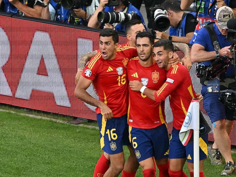 Spain celebrate win against Germany.