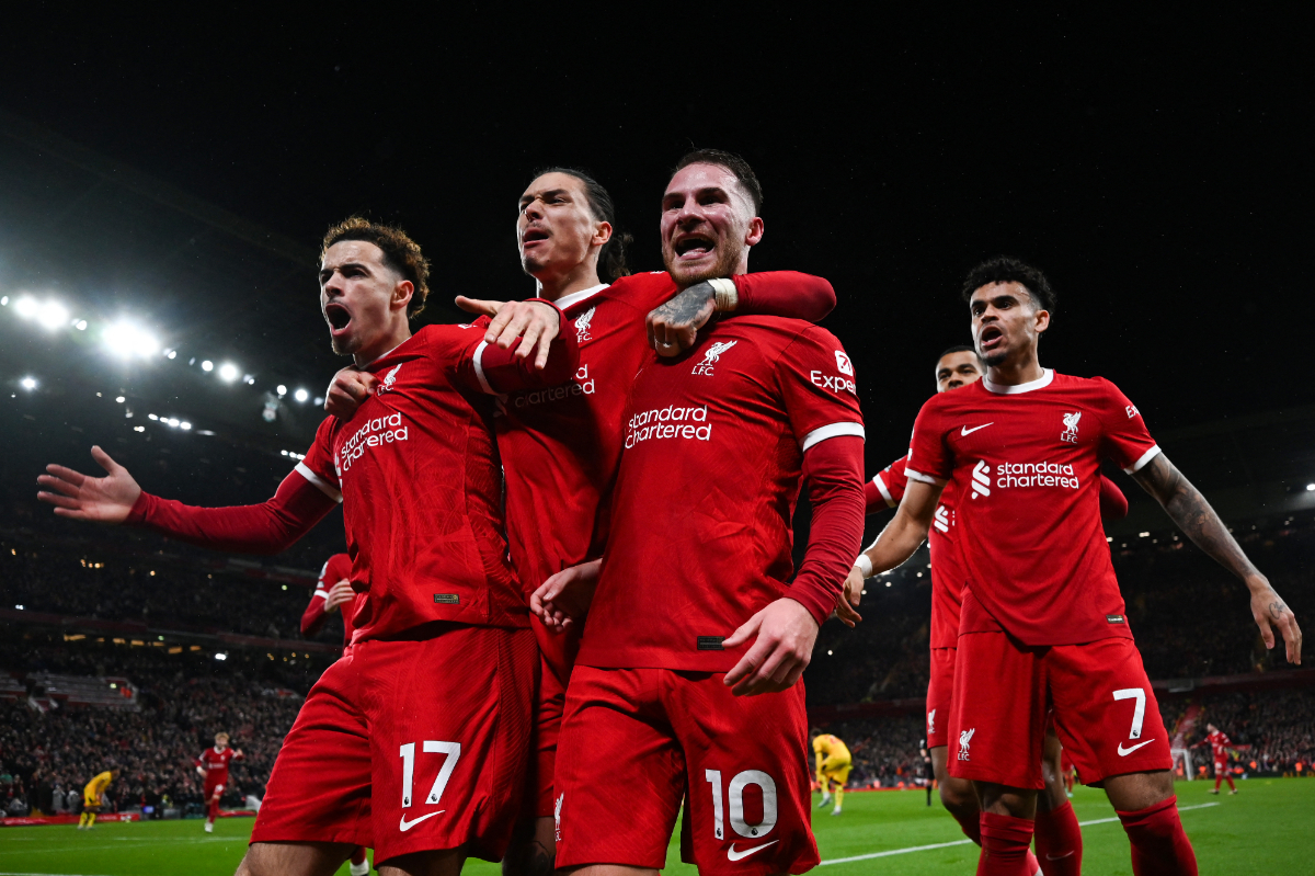 Liverpool's Argentinian midfielder #10 Alexis Mac Allister (R) celebrates with Liverpool's Uruguayan striker #09 Darwin Nunez (C) and Liverpool's English midfielder #17 Curtis Jones (L) after scoring his team second goal during the English Premier League football match between Liverpool and Sheffield United at Anfield in Liverpool, north west England on April 4, 2024.