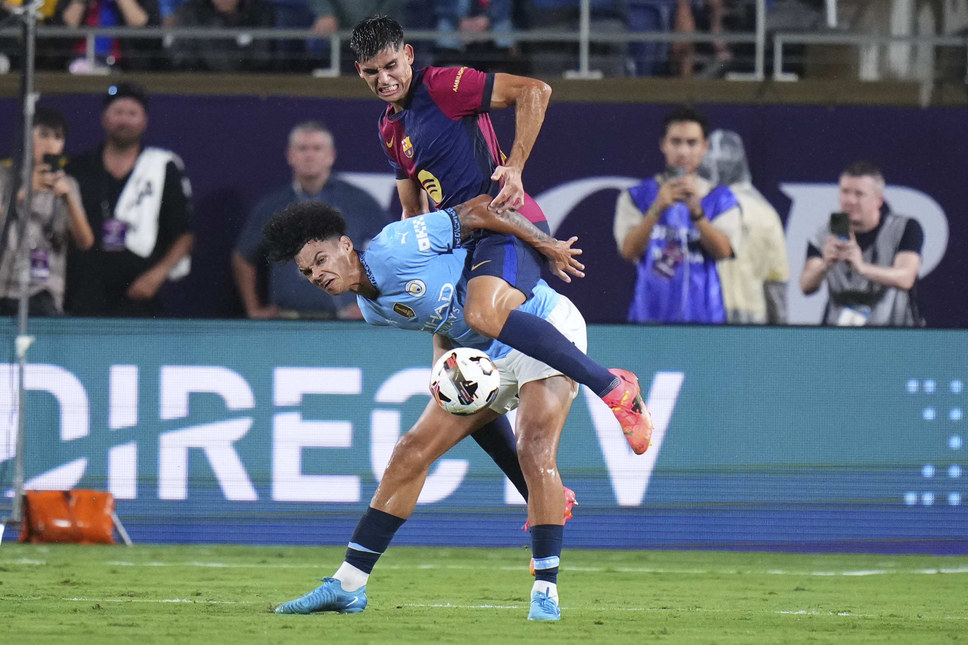 Marc Bernal #16 of FC Barcelona fouls Nico O'Reilly #75 of Manchester City in the first half during a pre-season match