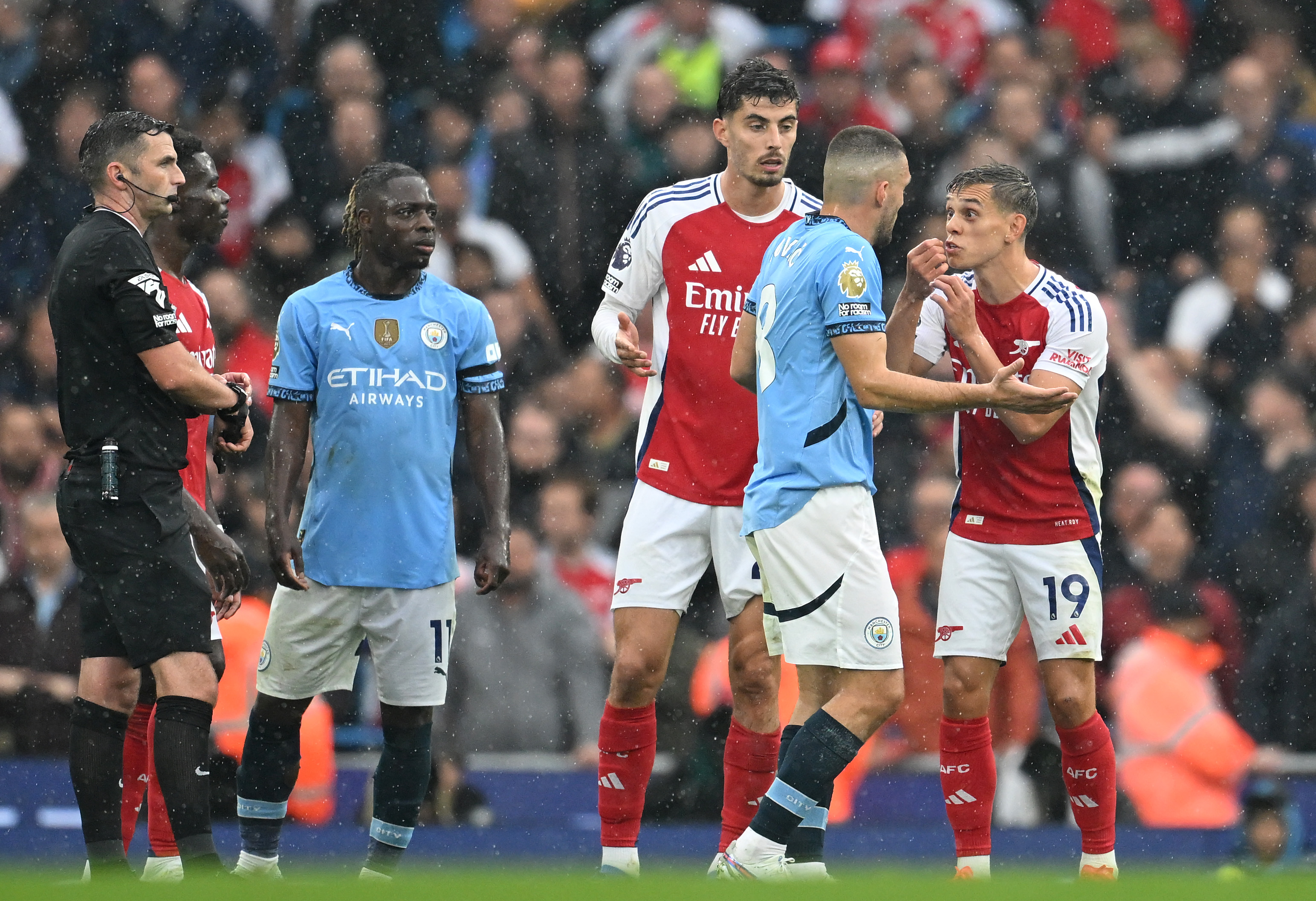 Leandro Trossard of Arsenal argues with Mateo Kovacic of Manchester City after being shown a red card. (Photo by Michael Regan/Getty Images)