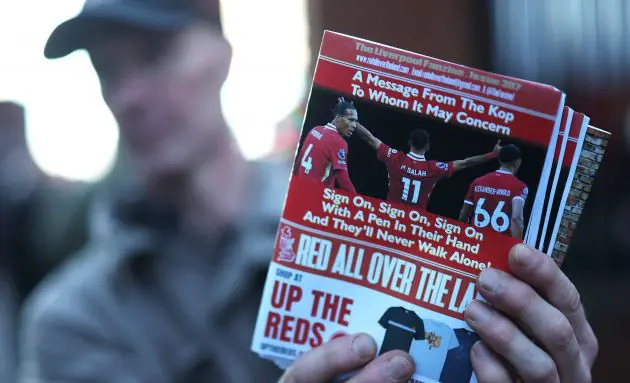 A Liverpool fanzine is seen being sold which features pictures of Virgil van Dijk, Mohamed Salah and Trent Alexander-Arnold