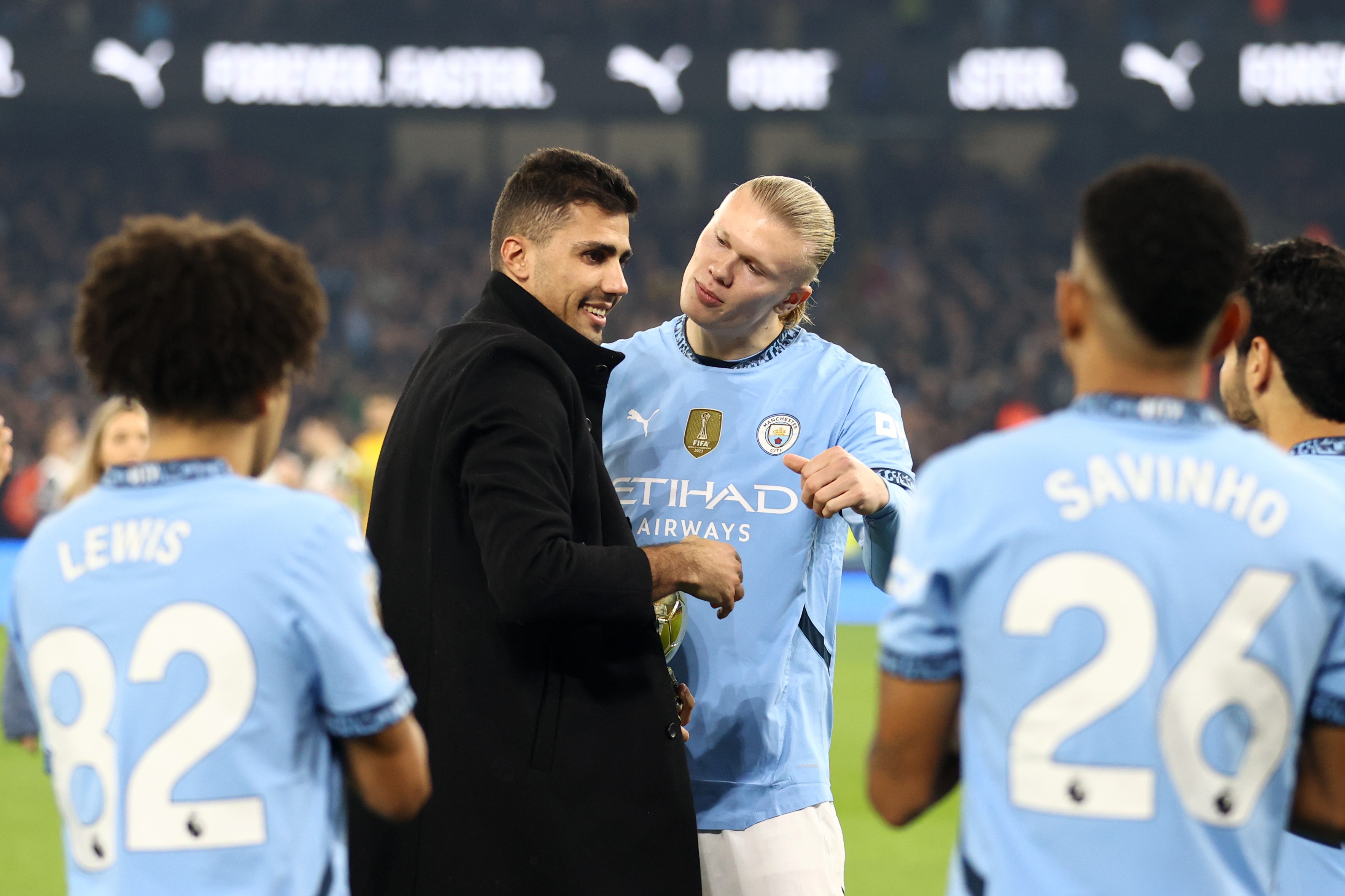 Rodri of Manchester City is congratulated by his team mates as he collects his Ballon d'Or.