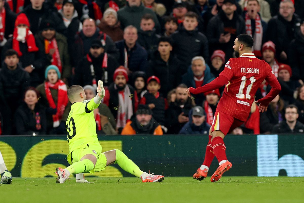 LIVERPOOL, ENGLAND - JANUARY 21: Mohamed Salah of Liverpool scores his team's first goal past Lucas Chevalier of LOSC Lille during the UEFA Champions League 2024/25 League Phase MD7 match between Liverpool FC and LOSC Lille at Anfield on January 21, 2025 in Liverpool, England. (Photo by Carl Recine/Getty Images)