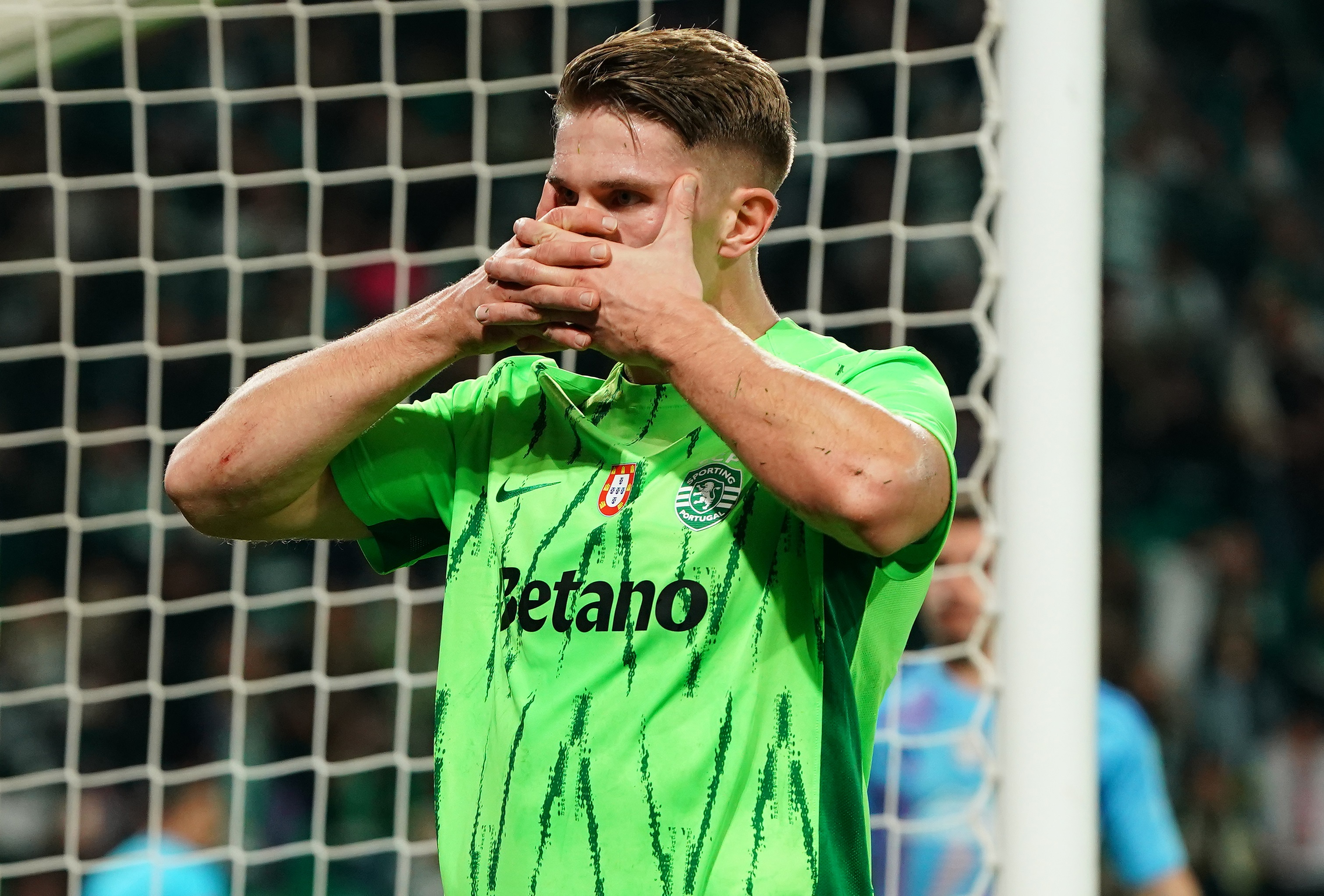 Viktor Gyokeres performs trademark goal celebration with hands in front of face.