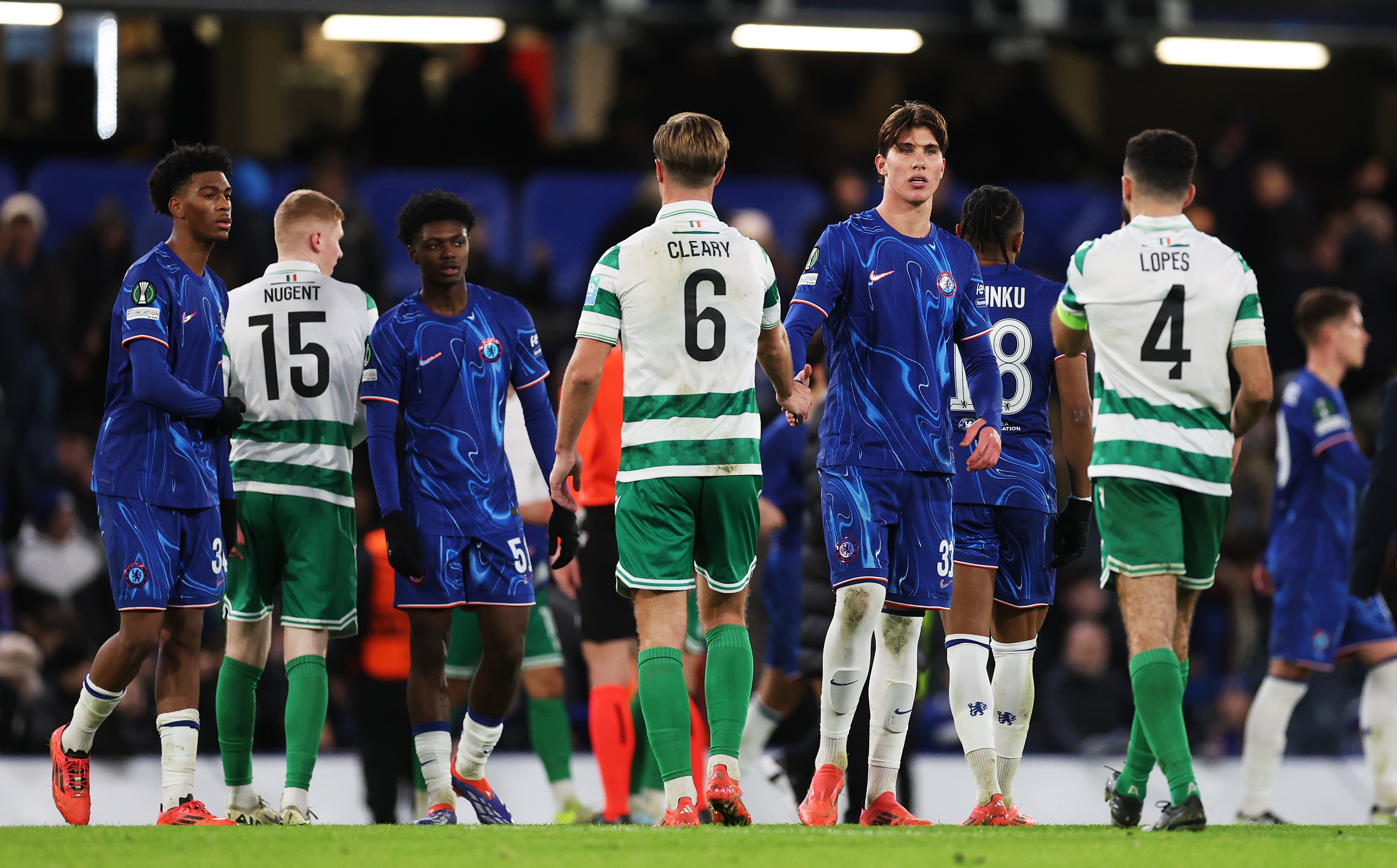 Cesare Casadei of Chelsea shakes hands with Daniel Cleary of Shamrock Rovers