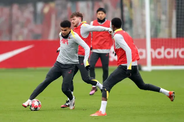 Luis Diaz of Liverpool controls the ball under pressure from teammate Harvey Elliott.