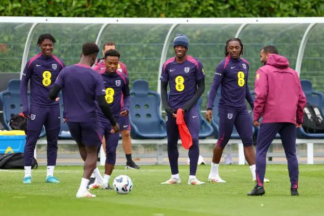 Kobbie Mainoo, Angel Gomes, Noni Madueke, Eberechi Eze and teammates look on during an England training session.