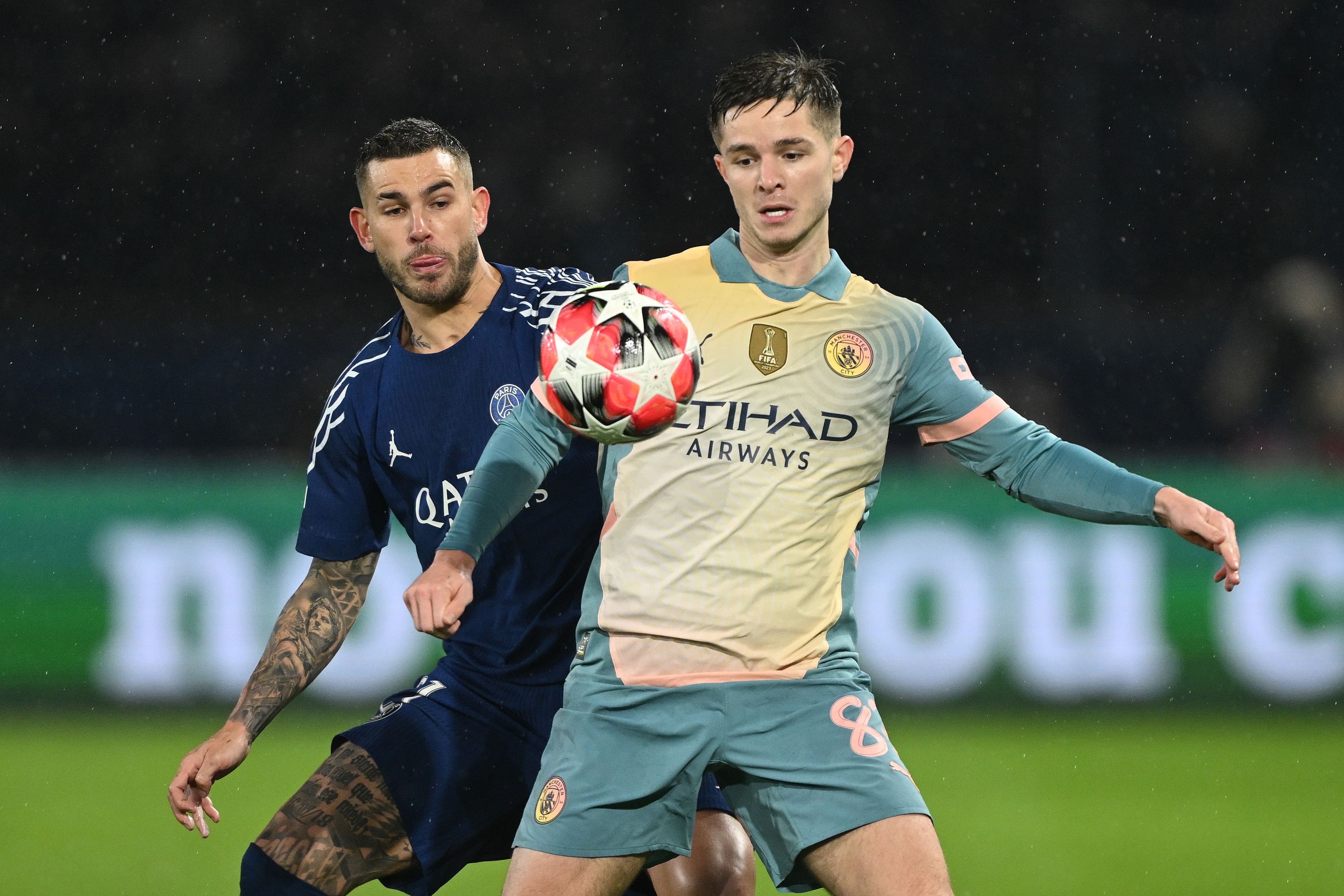James McAtee of Manchester City is challenged by Lucas Hernandez of Paris Saint-Germain