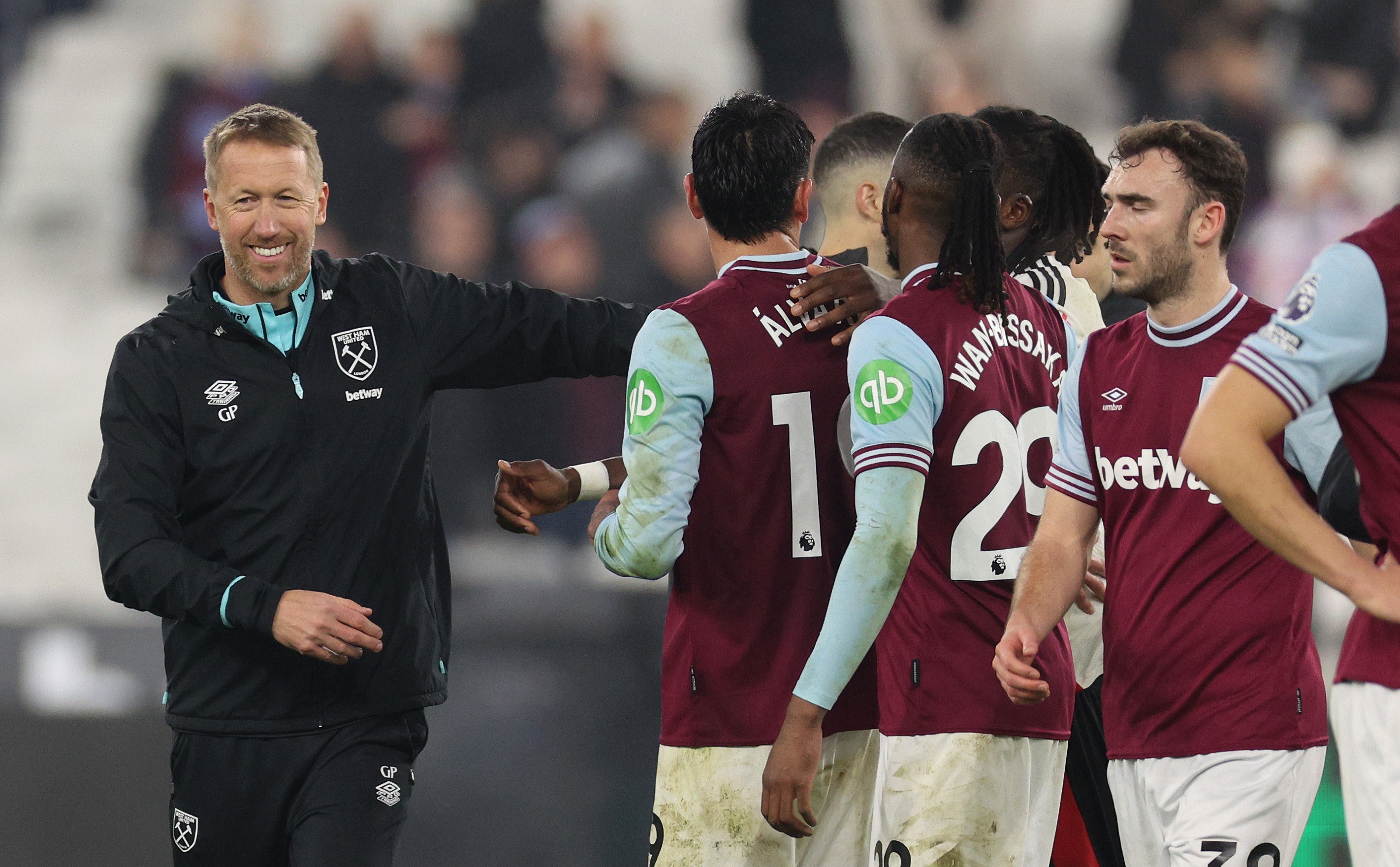 Graham Potter, Head Coach of West Ham United chats with his players