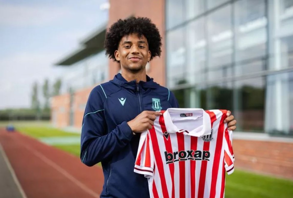 Jaden Dixon holding up a Stoke City shirt