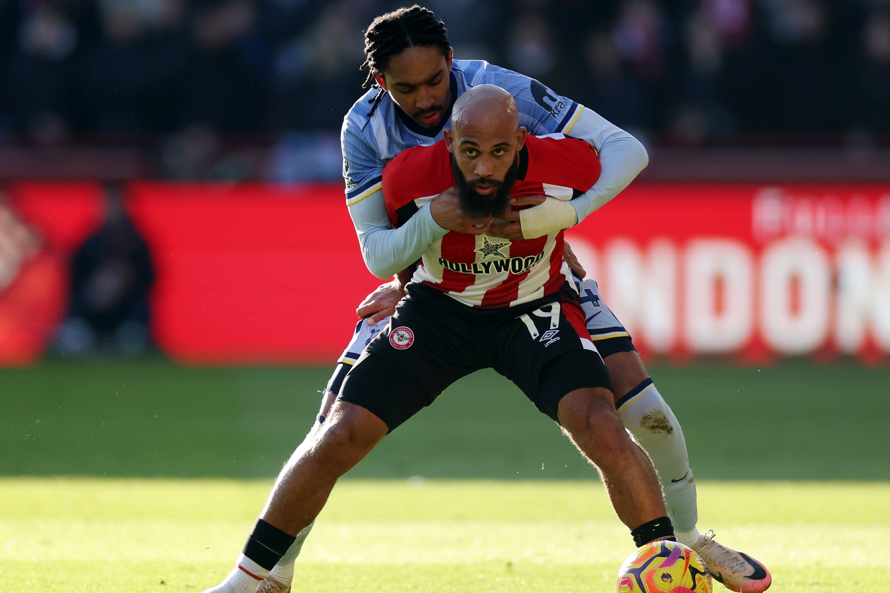 Bryan Mbeumo of Brentford is challenged by Djed Spence of Tottenham Hotspur