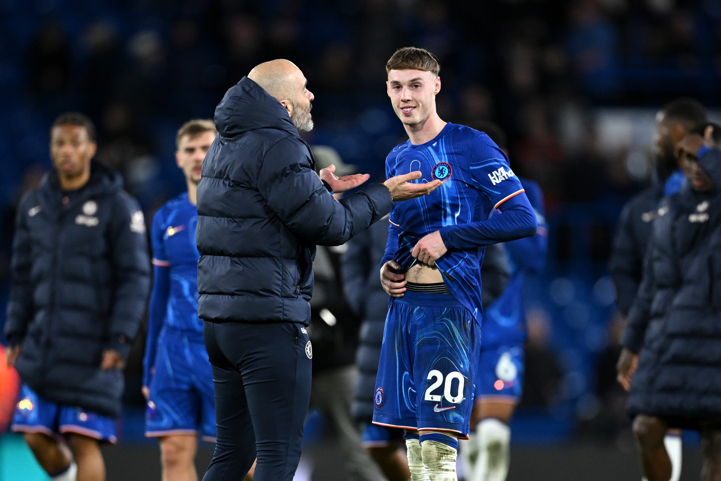 Enzo Maresca, Manager of Chelsea, speaks with Cole Palmer
