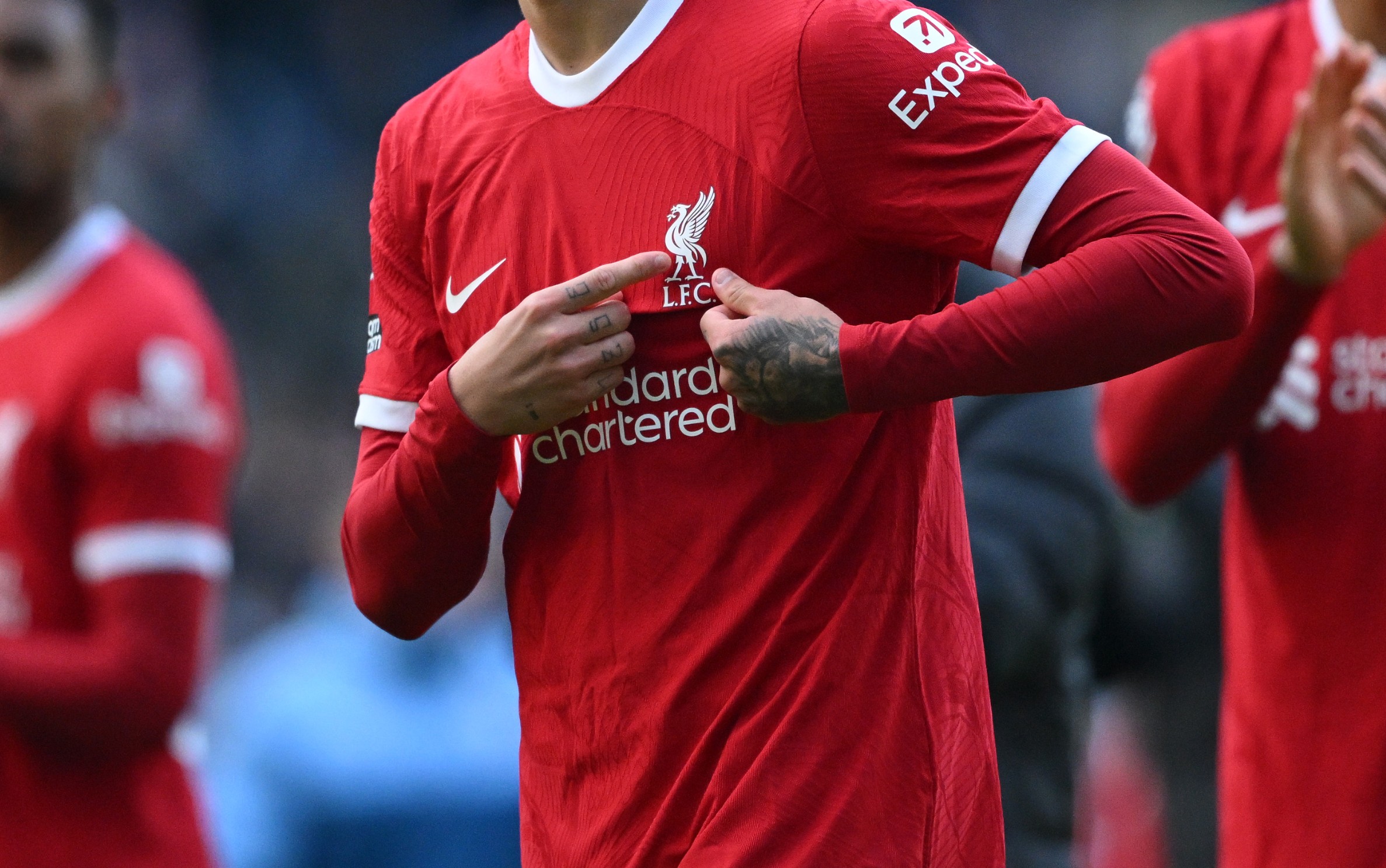 Darwin Nunez points to the Liverpool badge on his shirt