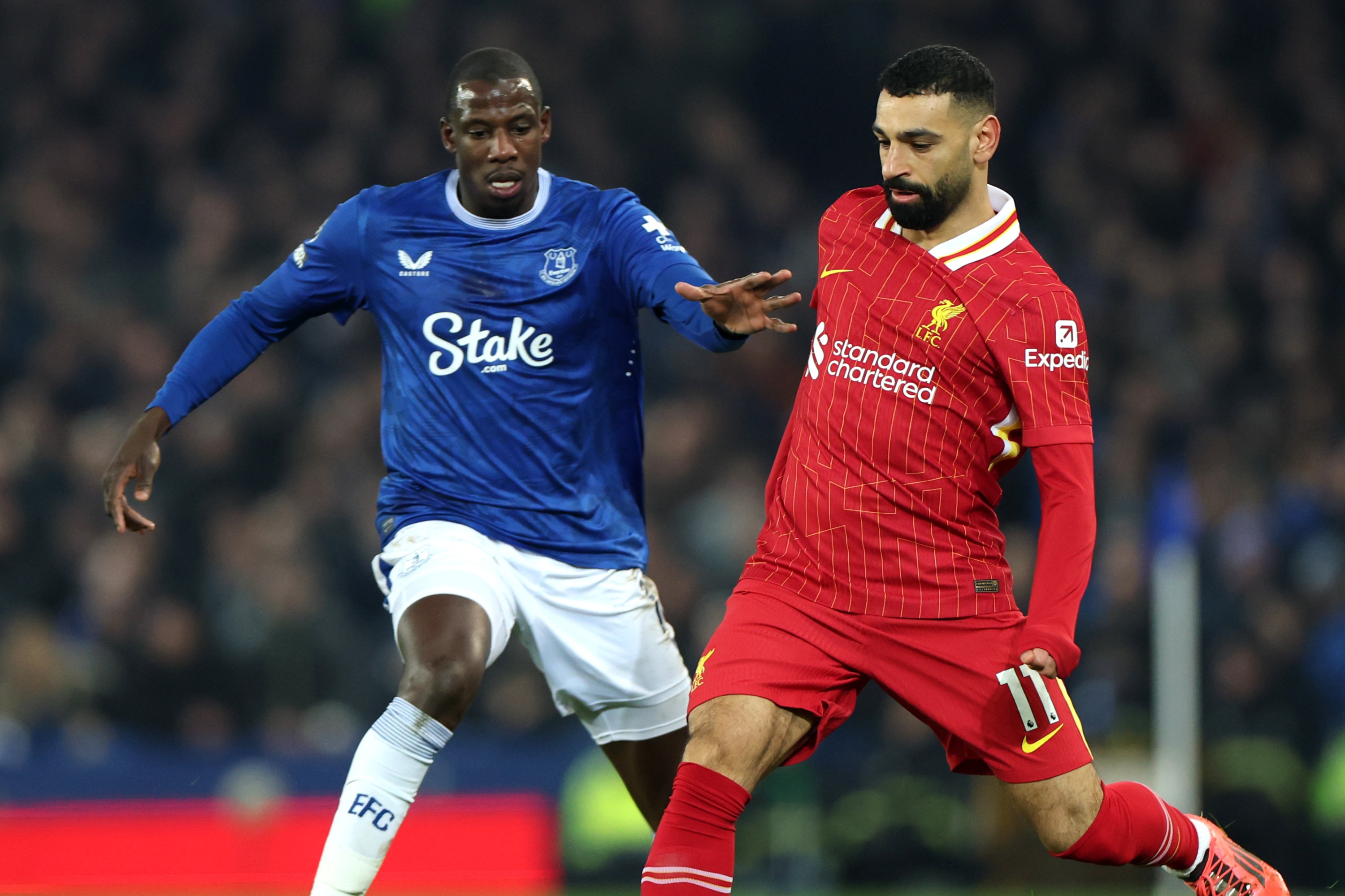 Mohamed Salah of Liverpool passes the ball whilst under pressure from Abdoulaye Doucoure of Everton