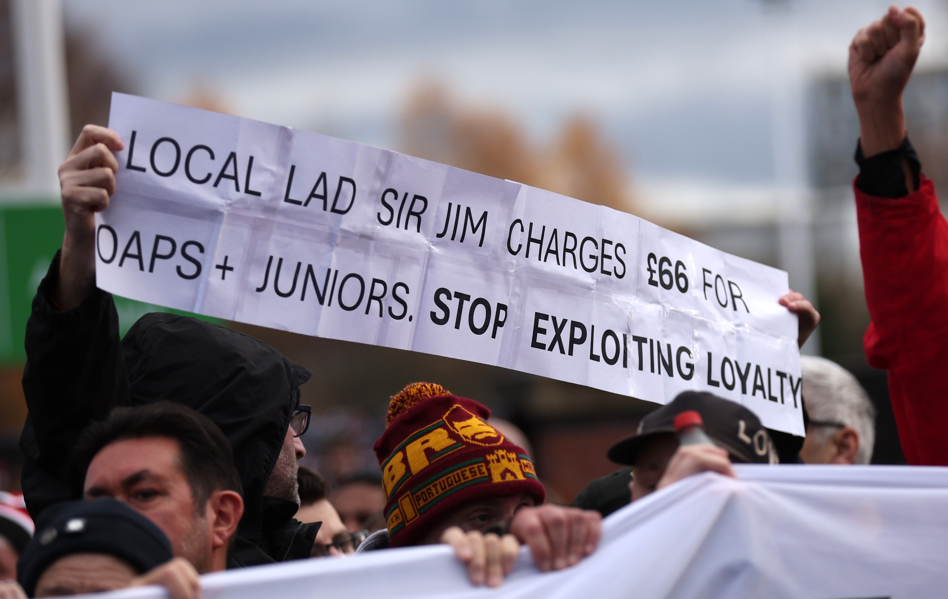 Fans of Manchester United are seen with a banner