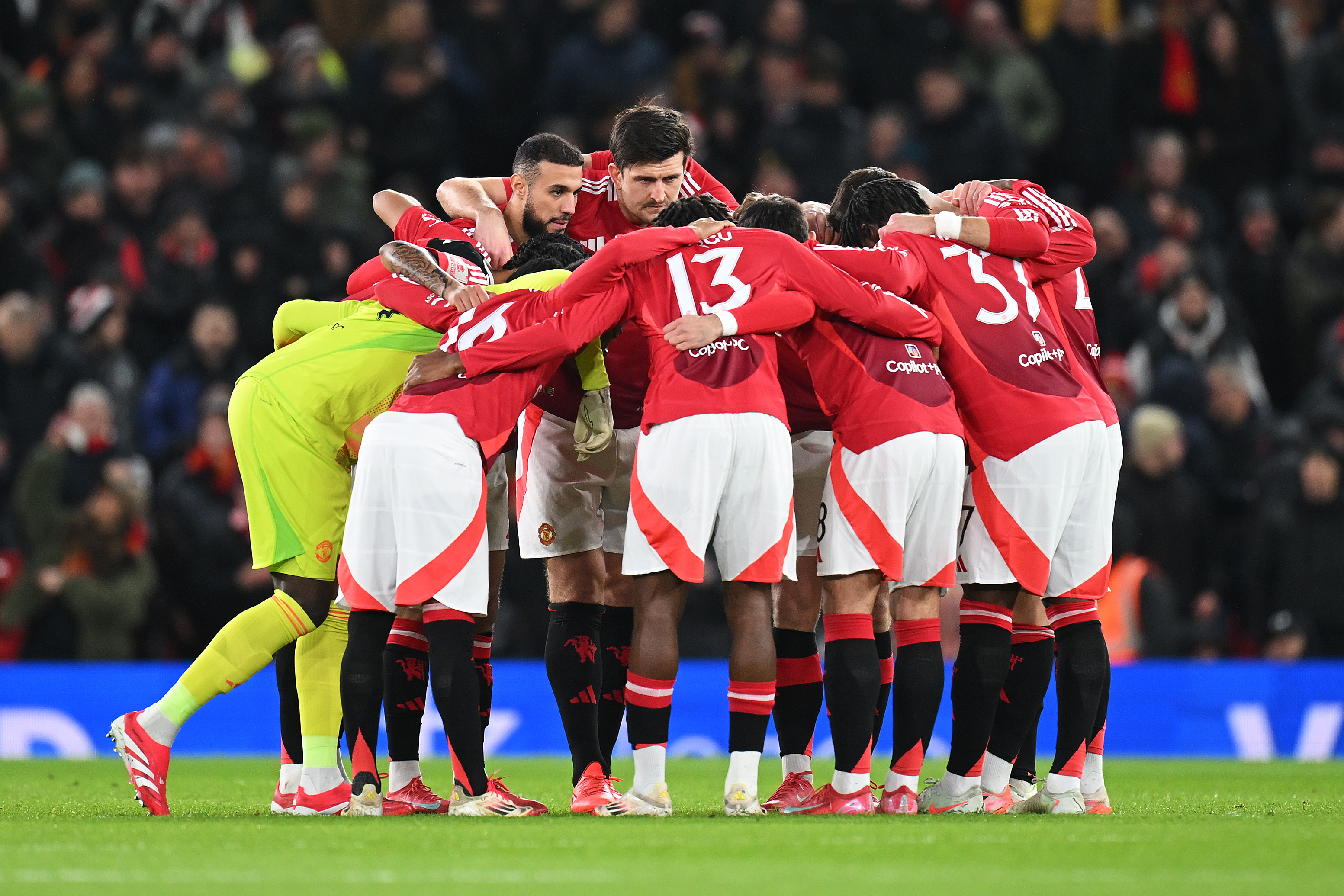 Manchester United players in a huddle during a match