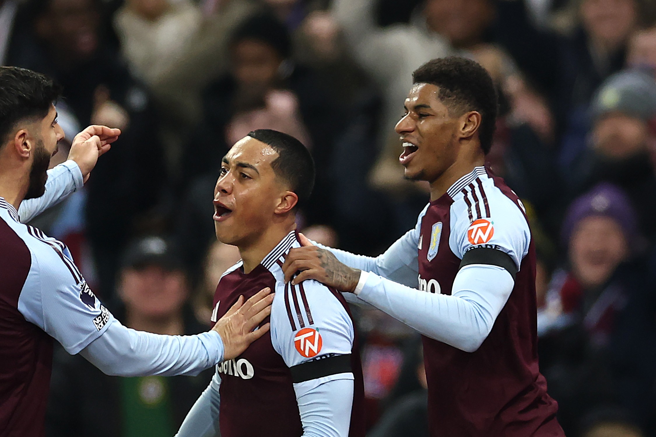 Youri Tielemans of Aston Villa celebrates scoring his team's first goal with teammates Marco Asensio and Marcus Rashford