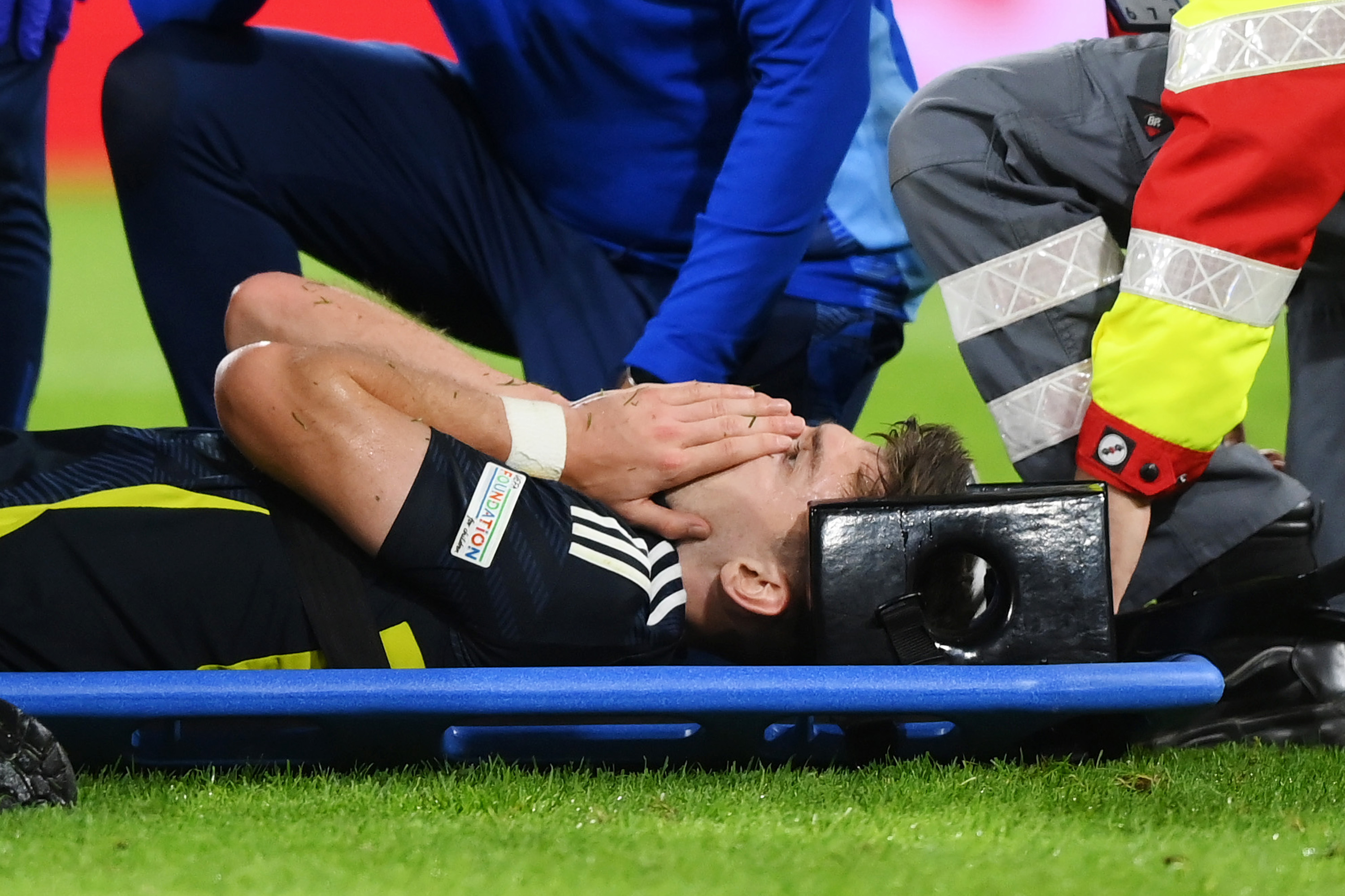 Kieran Tierney of Scotland reacts as he is stretchered off