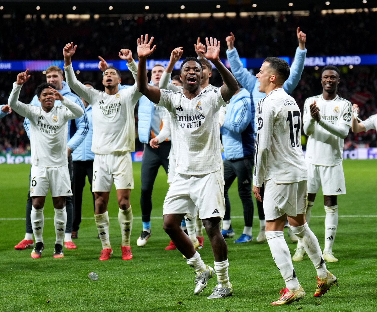 Real Madrid players celebrate after beating Atletico Madrid