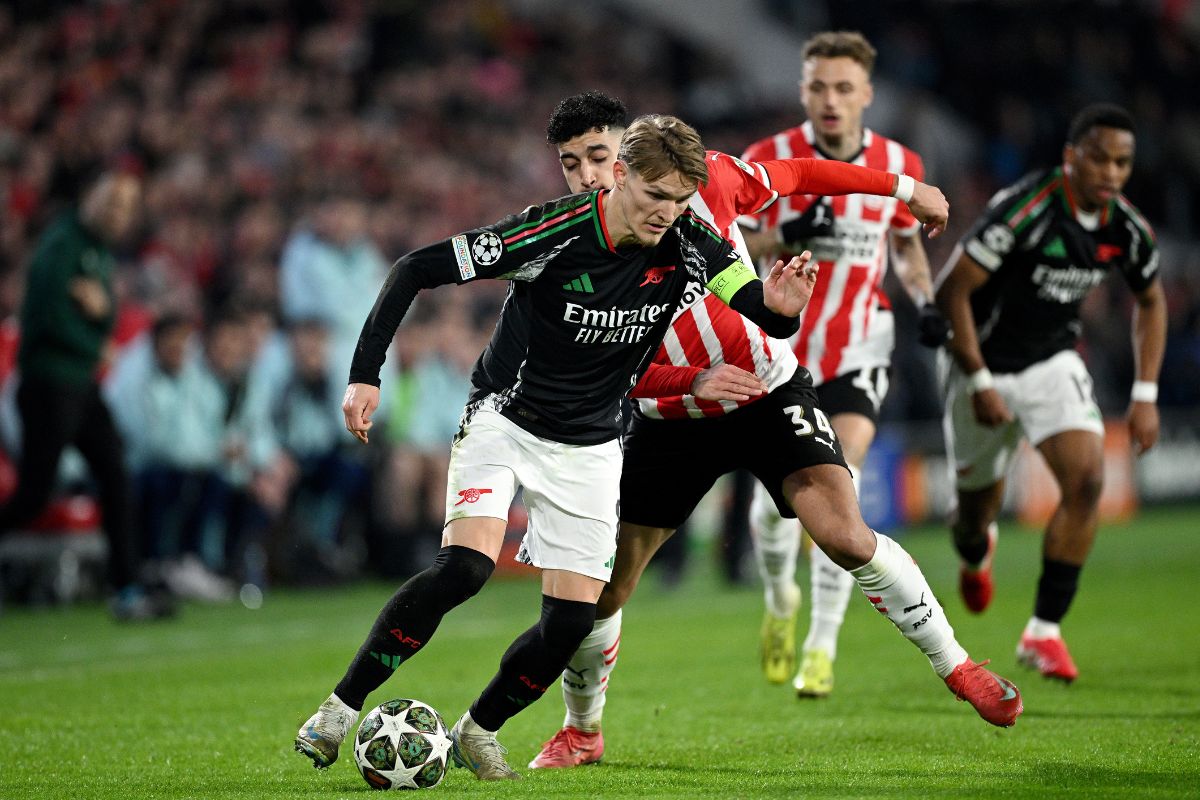 Martin Odegaard of Arsenal is challenged by Ismael Saibari of PSV Eindhoven