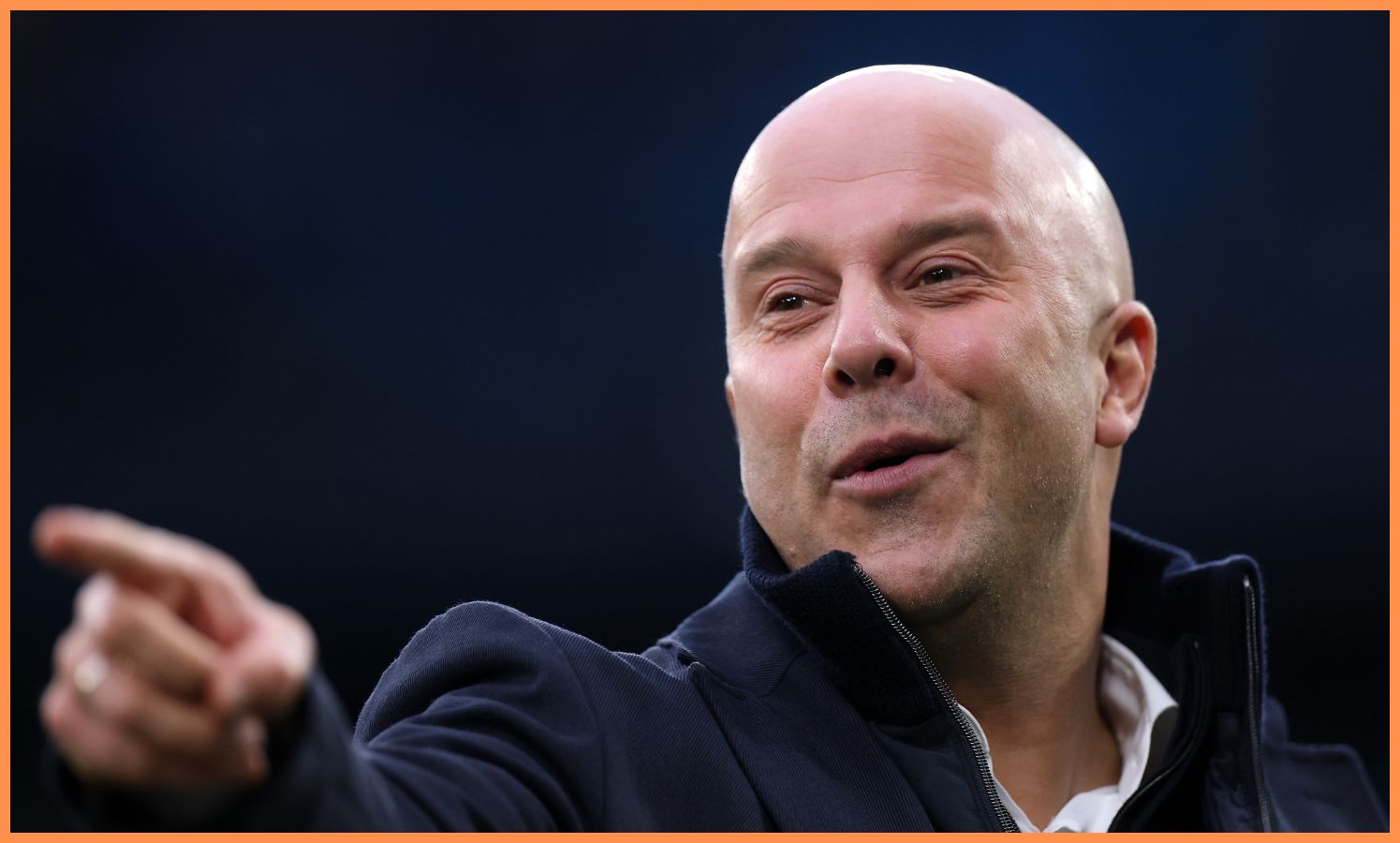 Liverpool head coach Arne Slot points at something at the Etihad Stadium.