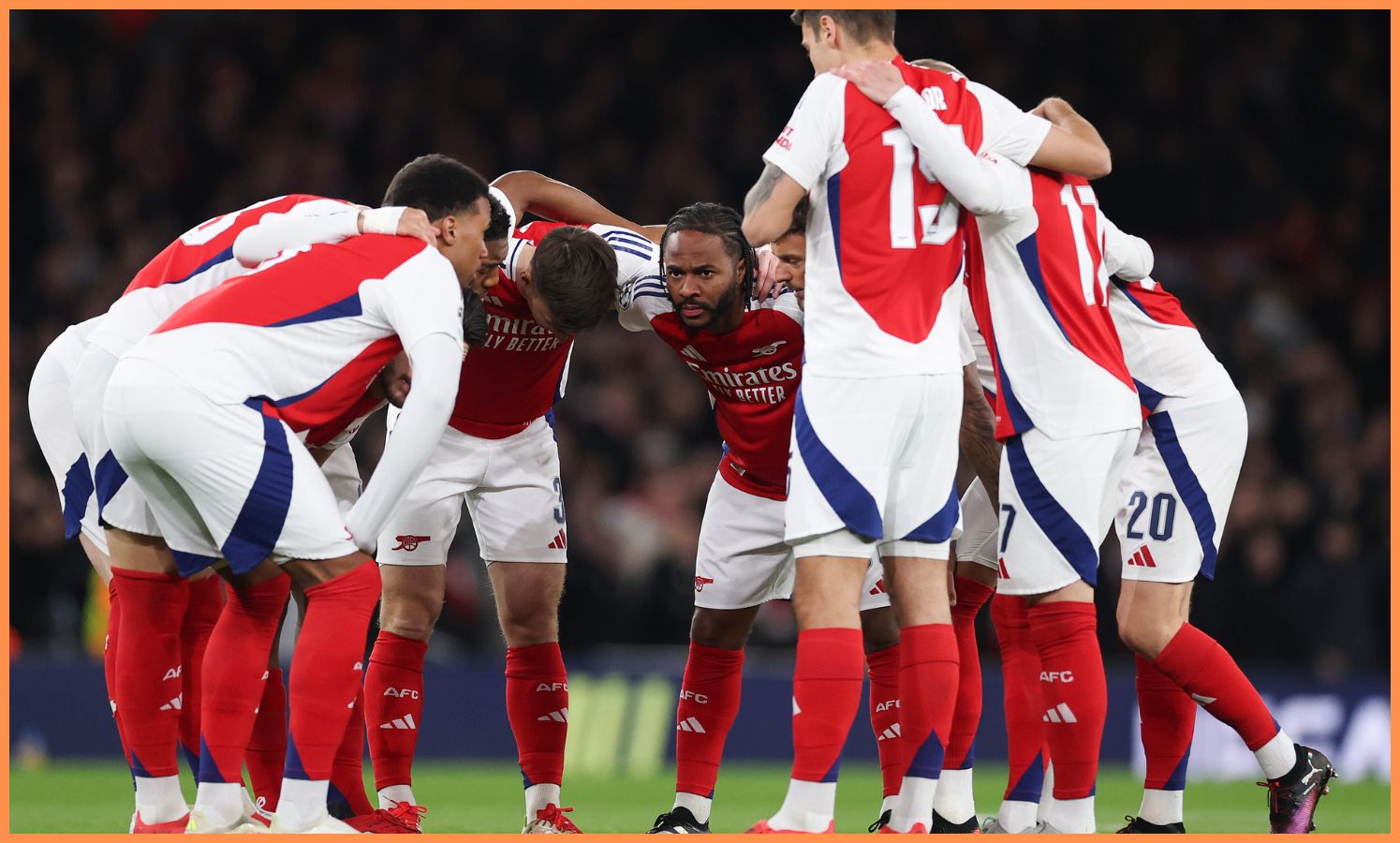 Raheem Sterling in a huddle with his Arsenal teammates