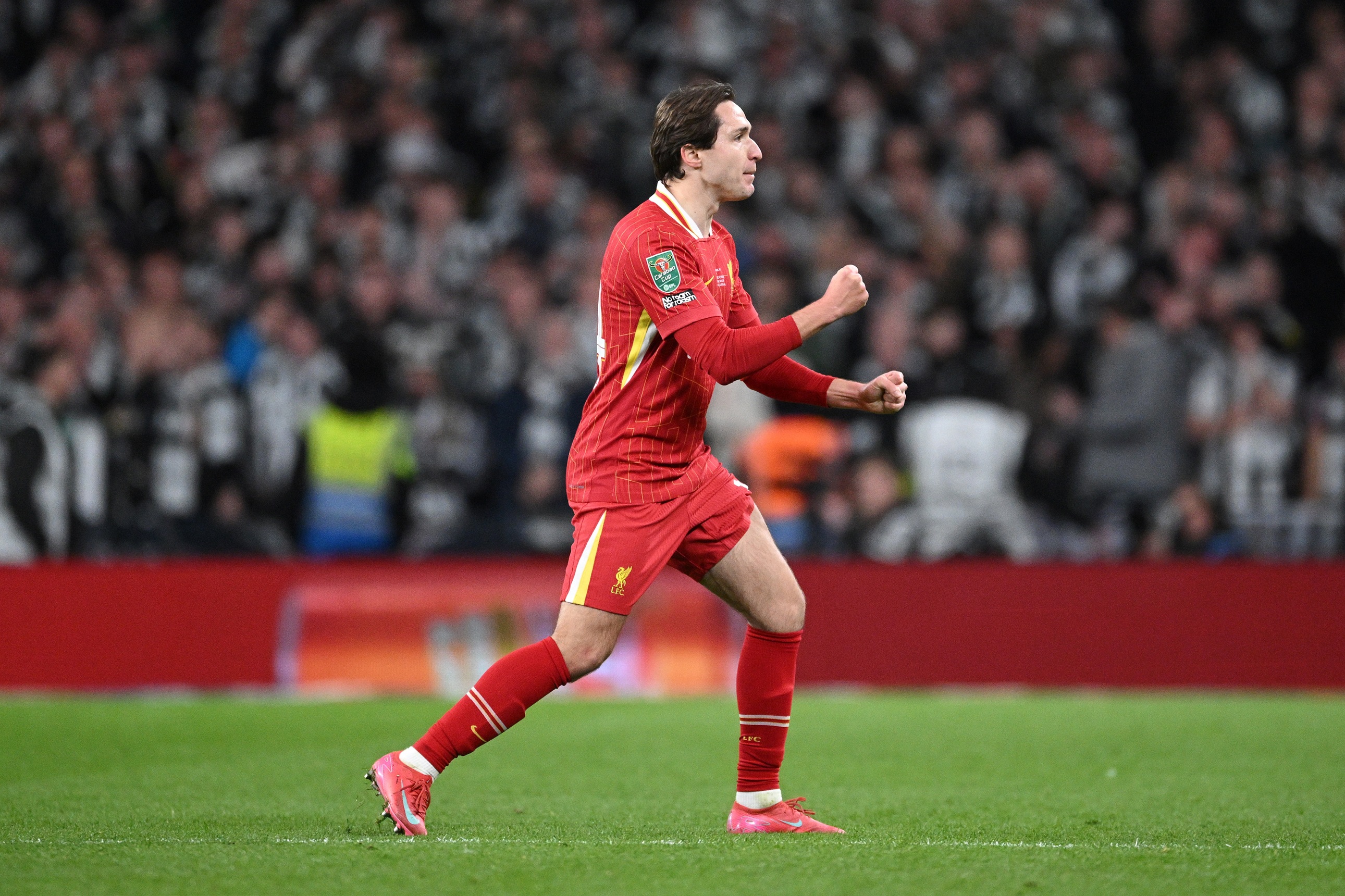 Federico Chiesa pumps his fists in celebration after scoring a goal.