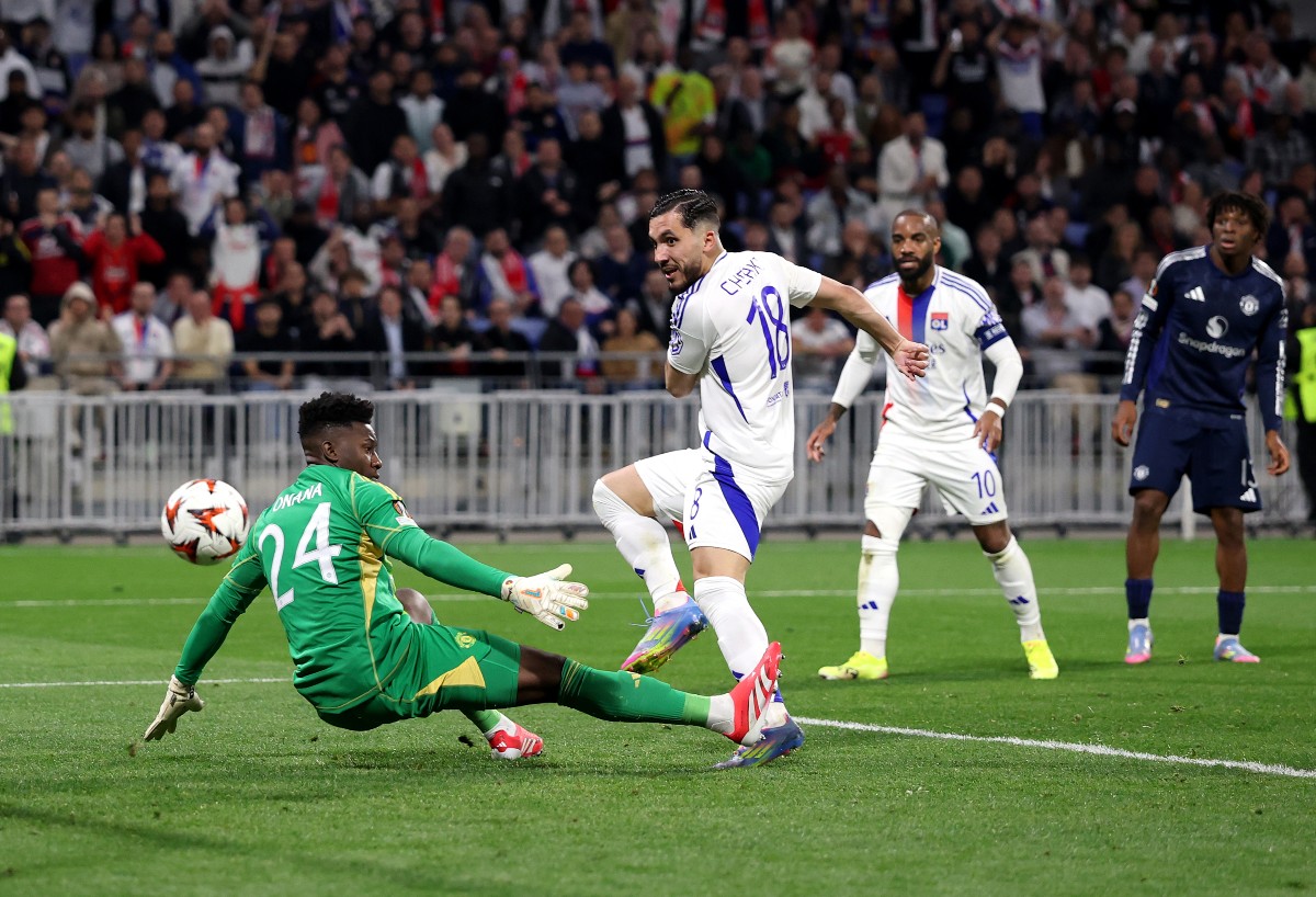 Rayan Cherki scores for Lyon against Man United goalkeeper Andre Onana