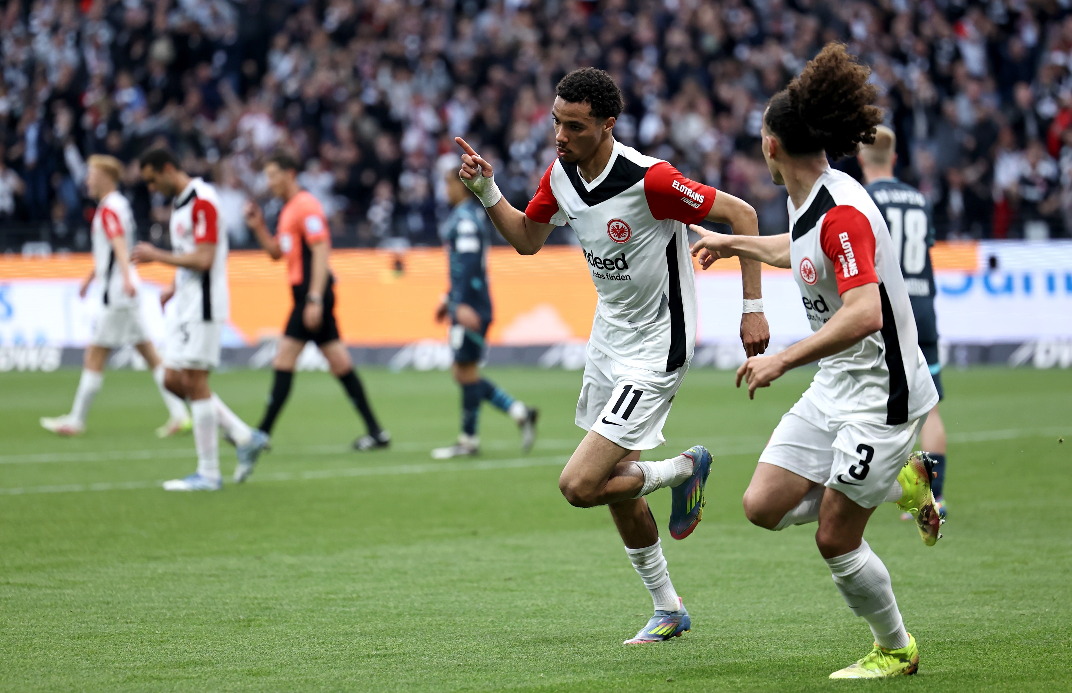 Hugo Ekitike runs away in celebration after scoring a goal.