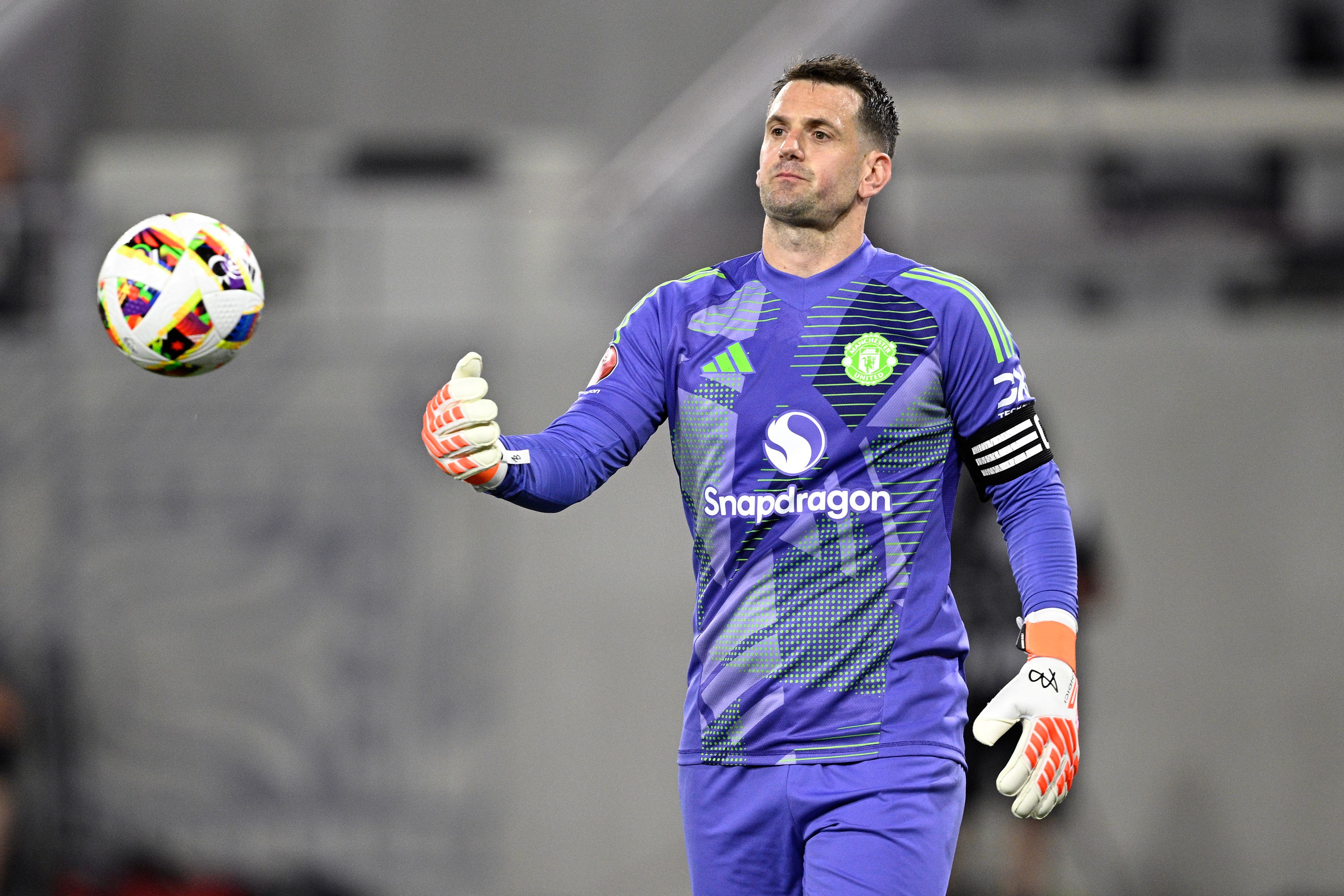 Tom Heaton #22 of Manchester United tosses the ball
