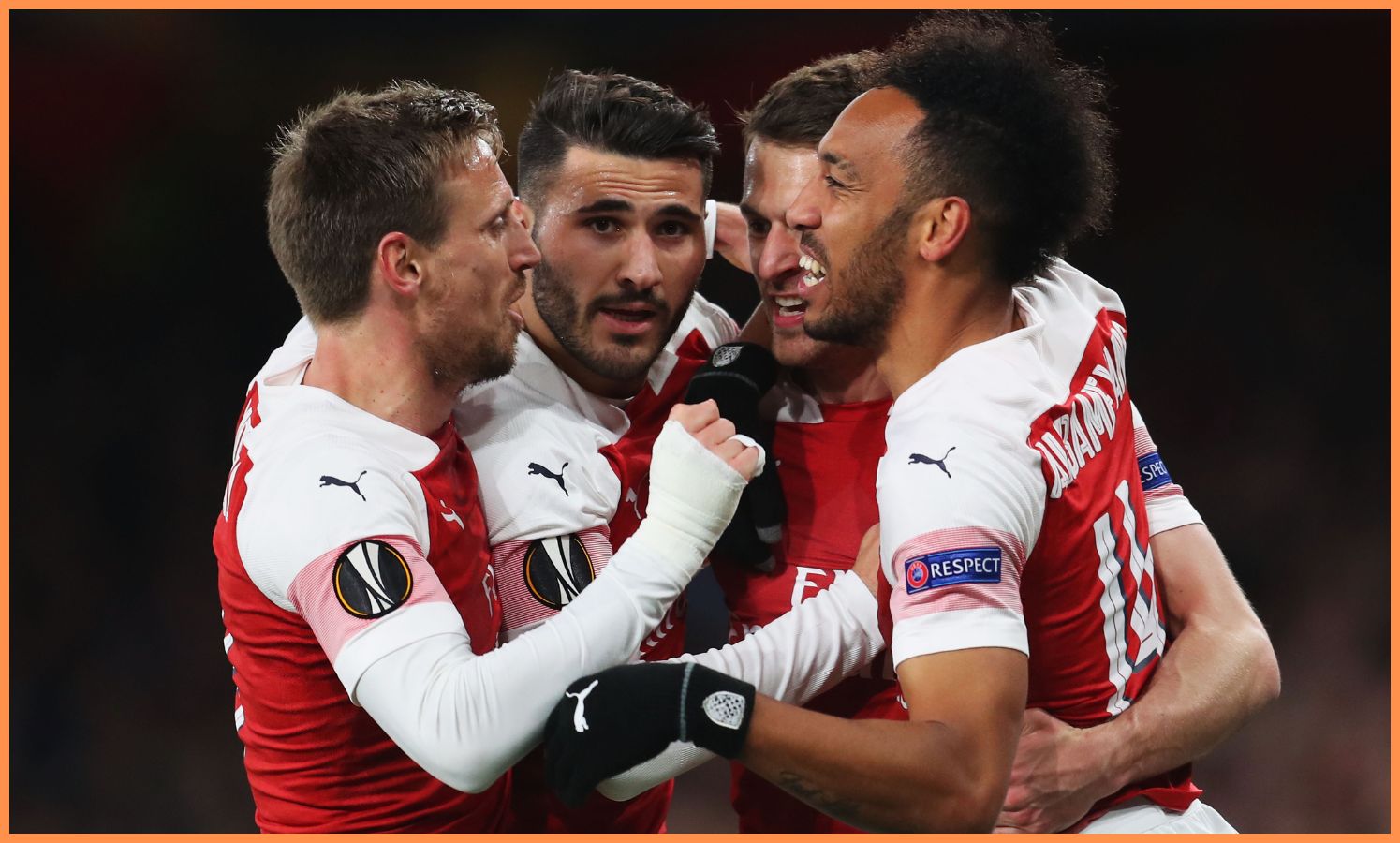 Aaron Ramsey celebrates with his Arsenal teammates in 2019