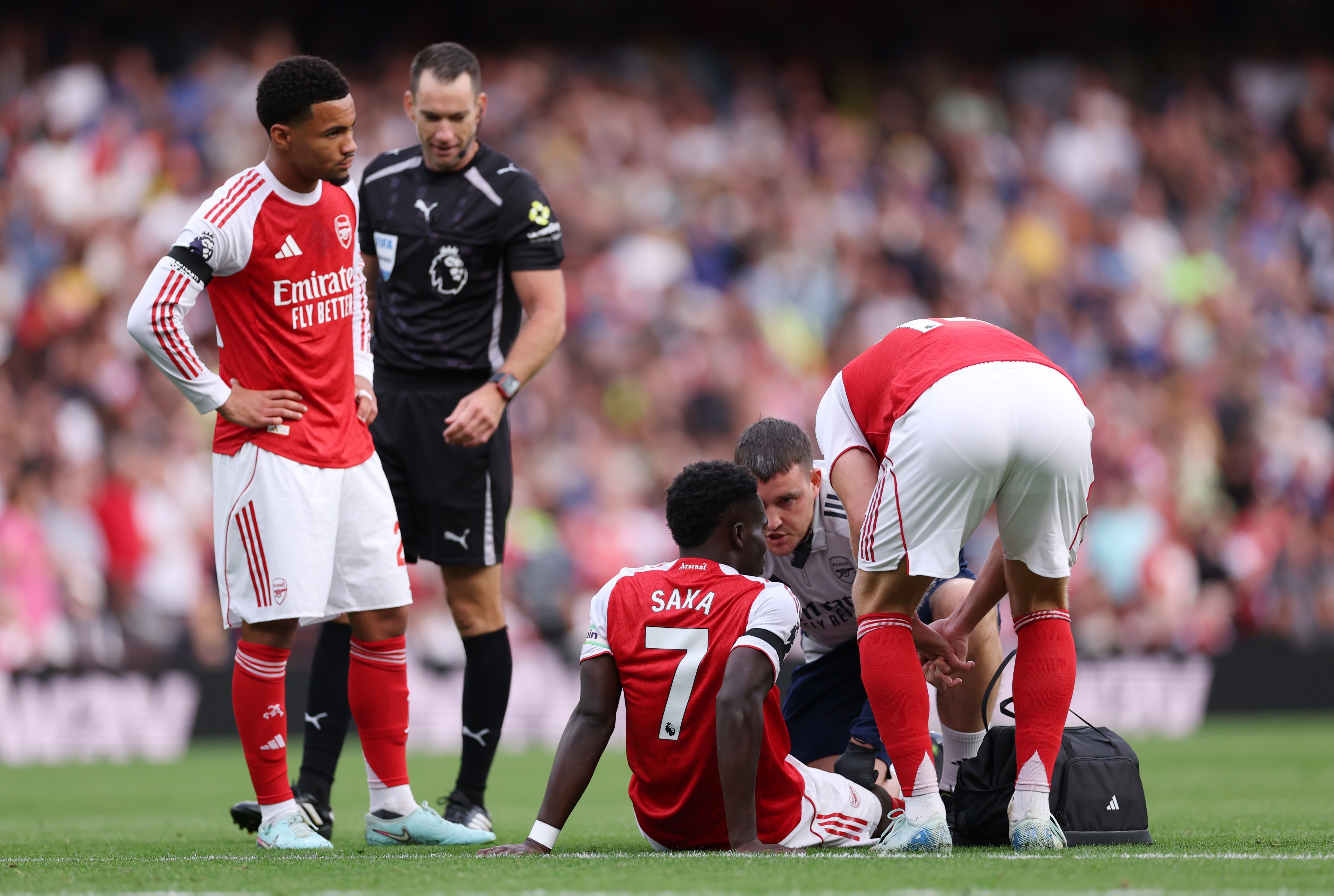 Bukayo Saka of Arsenal gets treated for injury during the Premier League match between Arsenal and Leeds United