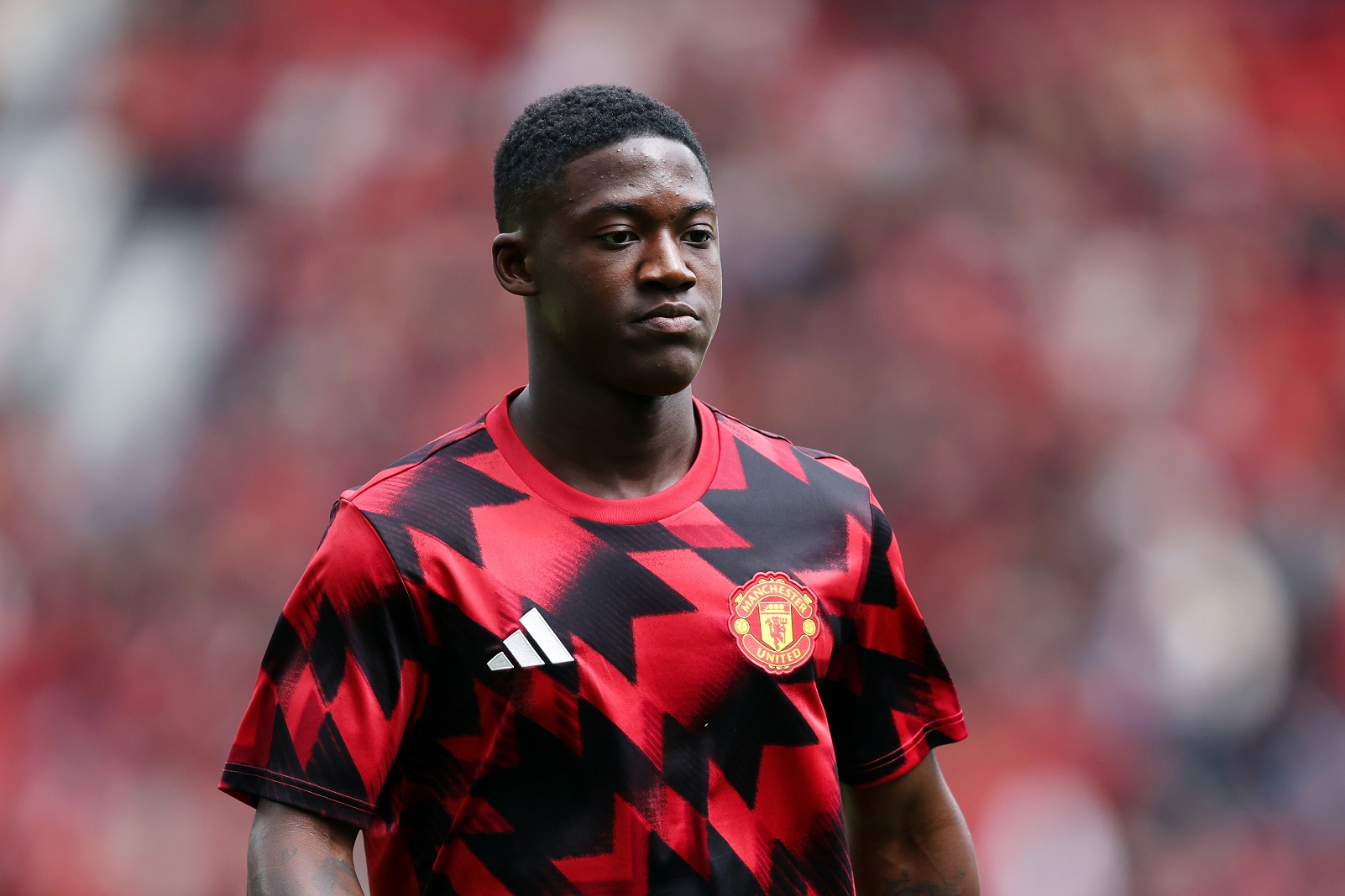 Kobbie Mainoo of Man United warms up during the pre-season