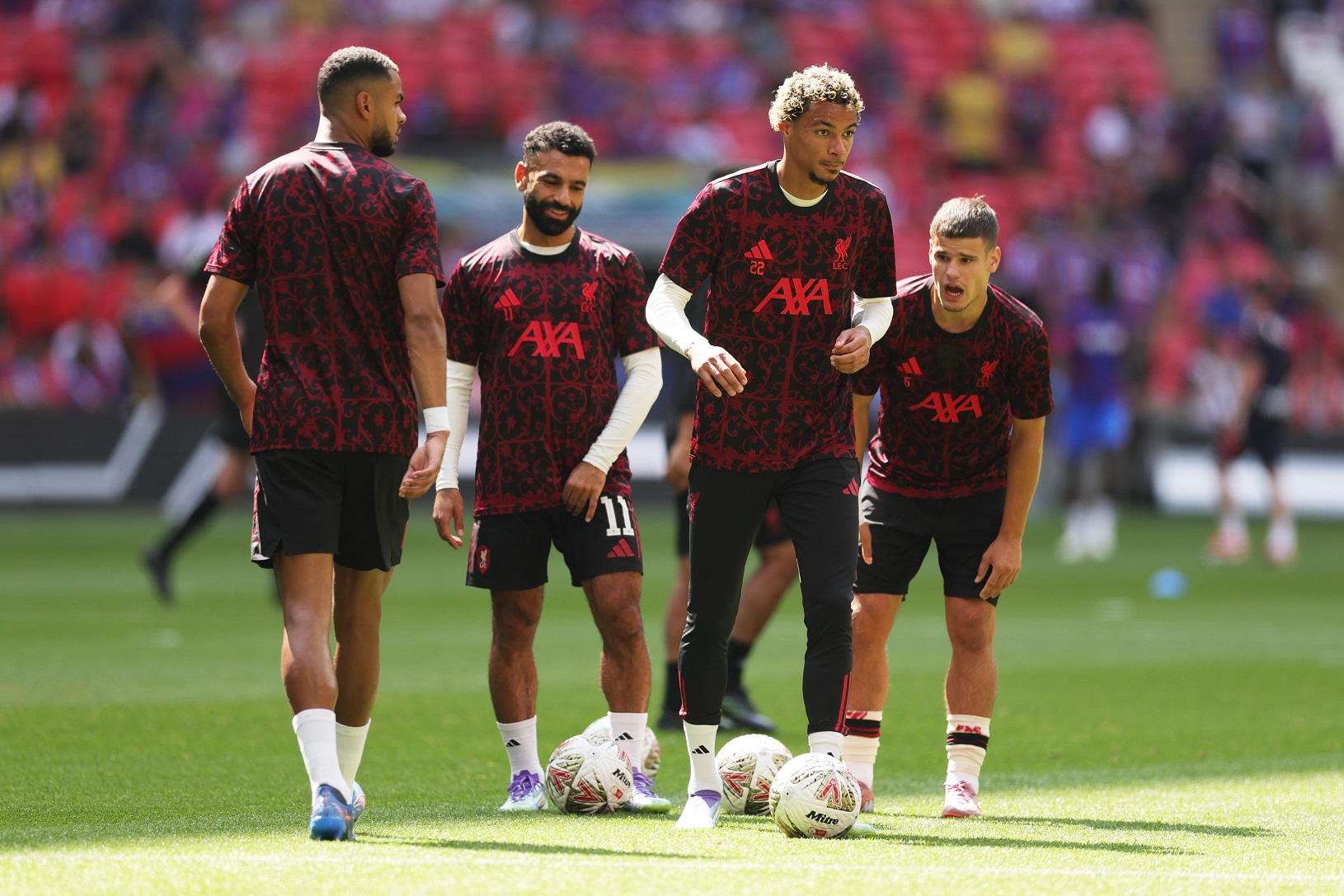 Cody Gakpo, Mohamed Salah, Hugo Ekitike and Milos Kerkez of Liverpool warm up 