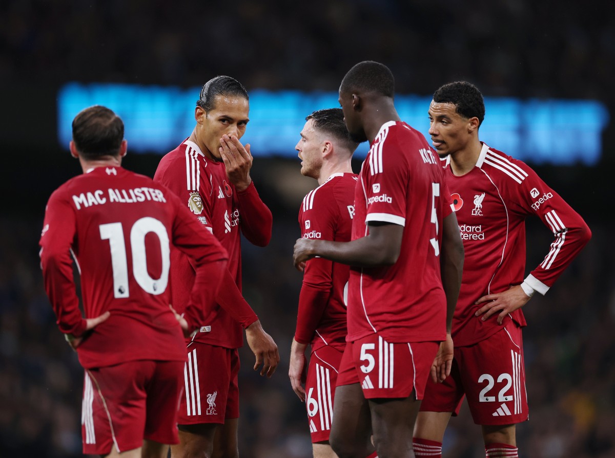 Virgil van Dijk talks with his Liverpool teammates